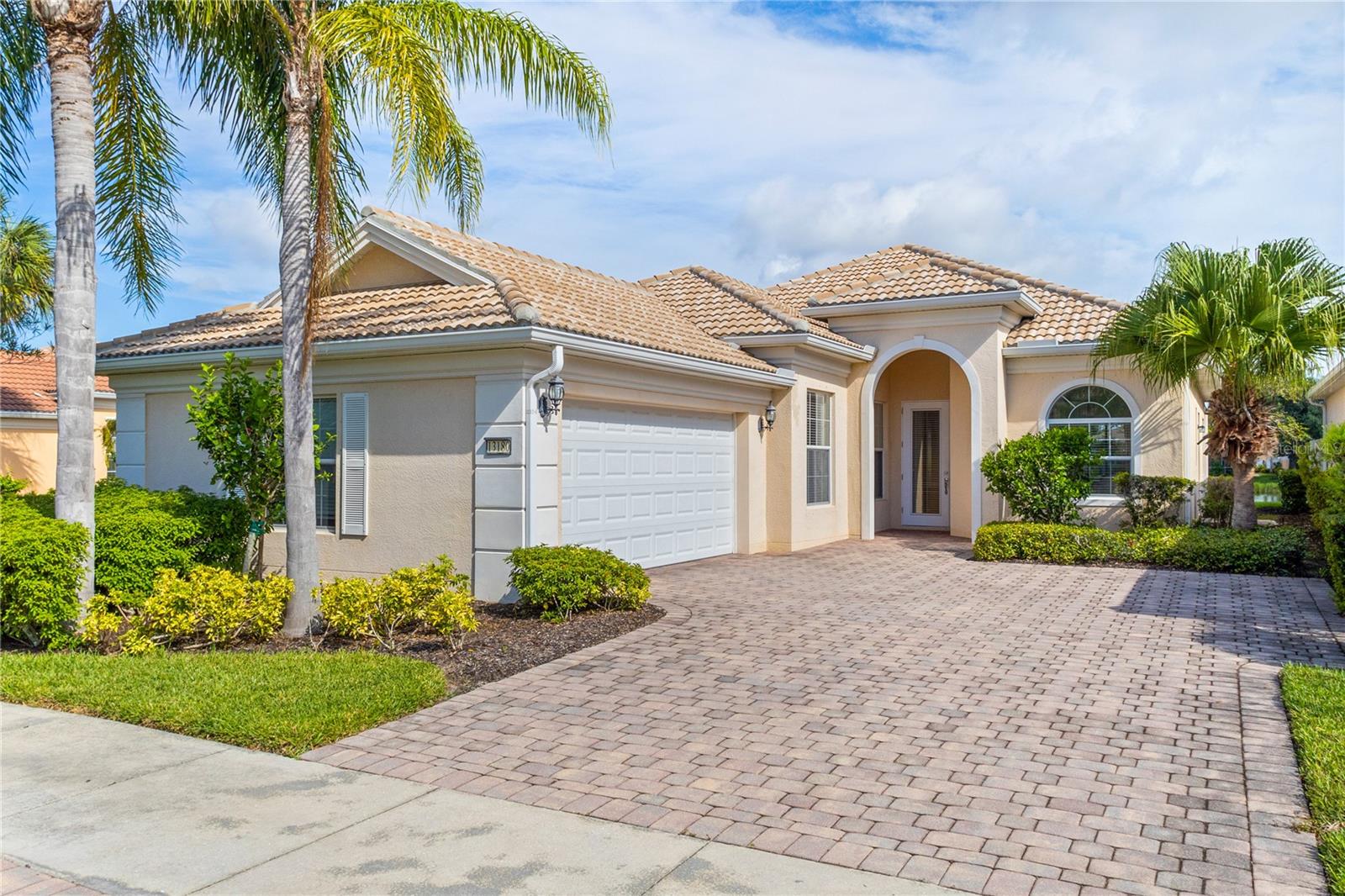 Virtually Staged. 20k Price Improvement! Welcome to this impeccably maintained Divosta Oakmont model, owned by a single owner. As you enter, you'll be greeted by breathtaking lake views and an open, flowing layout that seamlessly connects the Great Room, Dining Room, and Kitchen—ideal for both daily living and entertaining. The kitchen is a chef’s dream, featuring maple cabinetry, Corian countertops, and stainless steel appliances, all designed to keep you engaged with guests in the adjacent living area. High ceilings and 8-foot doors enhance the home’s spacious ambiance. The air conditioning system, just four years old, includes a transferable warranty and has been serviced biannually, with two additional service visits already paid for. The primary suite serves as a serene retreat with ample closet space and generously sized his and hers bathrooms. The split floor plan ensures privacy, with two additional bedrooms and a guest bathroom on the opposite side of the home. A versatile den offers a quiet space for work or relaxation and can be easily closed off for uninterrupted focus. The large laundry room features a drop sink and cabinets for added storage, leading to an oversized side-entry garage with an extended driveway. Step outside to the expansive covered and screened lanai, perfect for dining, entertaining, or simply relaxing while taking in the gentle breeze and panoramic water views. Privacy walls between you and your neighbors further enhance your outdoor enjoyment. Islandwalk is a pristine 830-acre gated community surrounded by lakes and preserves. With a full-time Lifestyle Director, the community offers a wealth of events, clubs, and activities to foster a vibrant social life. Amenities include three amenity buildings, a heated lagoon pool, a heated outdoor lap pool, bocce ball courts, pickleball courts, Har-Tru tennis courts, a dog park, a playground, a basketball court, and a community garden. The beautifully maintained grounds feature miles of nature and biking trails, Venetian bridges, and scenic water views. The location is exceptionally convenient, with a rear exit to Cool Today Park, the Atlanta Braves Spring Training Stadium, and the new Downtown Wellen Park, all just a short bike or golf cart ride away. Enjoy easy access to shopping, medical services, dining, and the stunning Gulf Beaches, with quick access to I-75. This home is being offered turnkey with all furnishings, dishes, cookware, silverware, TVs, and more. Don’t miss this opportunity to embrace the Florida sunshine and relaxed lifestyle!