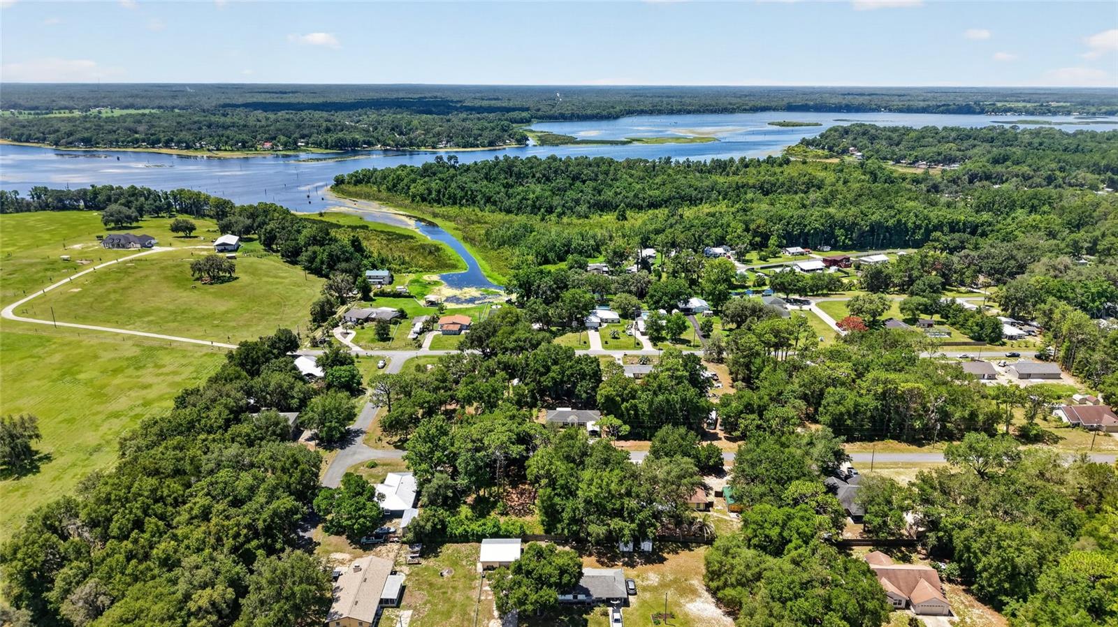 Welcome to your own slice of Old Florida paradise in the peaceful waterfront community of Peaceful Acres! Nestled on ½ acre beneath majestic oak trees, this beautifully updated 3/2/2 home offers 1,896 SqFt of comfortable living and an exceptional lifestyle surrounded by nature.  Perfectly situated on a canal with direct access to Lake Rousseau, you'll enjoy boating, fishing, kayaking, and unforgettable sunsets right from your backyard. Just a short boat ride away, the crystal-clear waters of the Rainbow River invite you to swim, paddle, tube, and explore one of Florida's most treasured natural springs.  Inside, the home has been thoughtfully remodeled with a warm, modern style. The kitchen, flooring, appliances, and bathrooms were updated in 2021, creating a move-in-ready space that blends comfort with functionality. The spacious layout offers generous indoor/outdoor living areas, ideal for both entertaining and everyday living.  Major updates provide peace of mind, including a 2018 roof, a 2024 HVAC compressor with a transferable warranty, a salt-based water treatment system, and a portable generator with hookups in the garage.  Step outside and discover what truly makes this property special. The expansive yard is a gardener's paradise and a haven for wildlife, where native plants, towering oaks, and a unique natural ecosystem create an ever-changing backdrop. Watch graceful herons, egrets, ibis, osprey, and even majestic bald eagles from your own backyard while enjoying the peaceful canal views.  Beyond the property itself, Peaceful Acres is known for its welcoming atmosphere and strong sense of community.  Regular gatherings and social events make this one of Dunnellon's hidden gems where your neighbors quickly become treasured friends.  Whether you're looking for a full-time residence, weekend retreat, waterfront escape, or investment property, this home offers the perfect balance of modern updates, natural beauty, and relaxed Florida living—all within easy reach of Rainbow Springs State Park, the Rainbow River, Ingles, Crystal River, the Inverness area with your choice of shopping, dining, and the charm of these historic downtown communities.  Experience the peaceful waterfront lifestyle you've been dreaming of—where every day feels like a vacation.