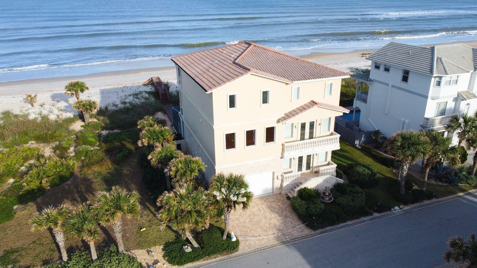 DIRECT OCEANFRONT – OCEAN DUNE CIRCLE IN ARMAND BEACH ESTATES - Here, excellence means one-of-a-kind homes with luxury design, custom builds, and a quiet and serene beach setting.  The coquina beach allows for walking miles in either direction. secluded Ocean Dune Circle is the coveted location for homeowners in this community with a private gated beachside community with low HOA fees.   This Stajo Construction built home is appointed with exquisite craftsmanship throughout including custom milled moldings/wood work, porcelain, marble and granite flooring, bronze custom stair railings, cherry built ins and attention to the highest detail where quality materials are evident. Resort style pool and spa plus a private dune walkover to the quiet coquina beach make this the perfect beach home for your family.  You’ll love the expansive lanai where you can relax and soak in the serene water views and brilliant sunrises.  This exquisite home was built in 2007 with a stem wall with concrete block construction on a homesite offering 75 feet of direct oceanfront frontage.   Luxurious living with expansive windows and abundant views of the Atlantic from three floors. Elevator accesses all three levels.  Second floor has open floor plan Living room with gas fireplace and tall accent ceiling plus kitchen. Kitchen has two adjacent prep kitchens and outfitted with an amazing appliance package. Third floor has enclosed solarium overlooking the ocean.  Adjacent lot 7 is offered at $860,000 with 75’ direct ocean frontage.  The ultimate in Florida Luxury living. Schedule your tour today!