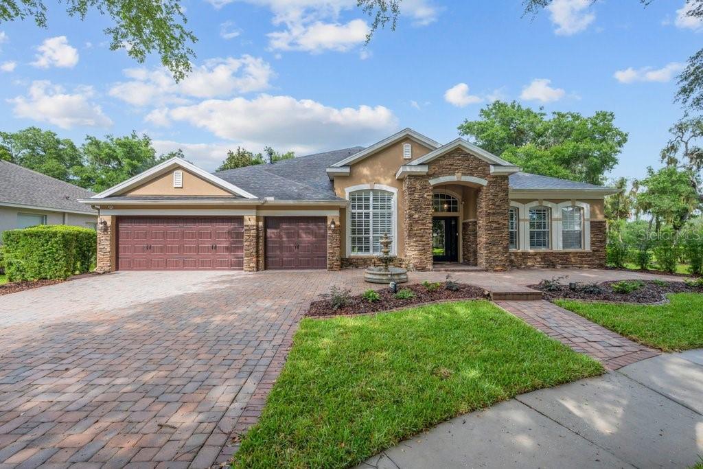 Tucked behind the Gates of Prestigious Kestrel Ridge in Fishhawk Ranch, This Magnificent David Weekly 'Florence' model home boasts 4400sqft of living space and sits on just shy of a 1/3 ACRE - CONSERVATION / CUL DE SAC LOT! This well-designed tremendous plan offers 4 bedrooms (5th possible) , 4 FULL bathrooms, **P L U S ** Home Office, TWO BONUS ROOMS (upstairs & downstairs), Formal areas, Great Room, Enclosed Florida Room and More! You are welcomed home to a handsome elevation dressed in brick pavers and front porch. Step inside the Grand Foyer and Your eyes are drawn to a picturesque backdrop featuring a sparkling pool and natural tree line. Immediately opening to a formal living and dining rooms and flanked by private home office. The formal dining room has a tray ceiling and flows easily into the gourmet kitchen. The spacious kitchen features rich maple 42" cabinetry with spacious counters, breakfast nook, built in appliances, double ovens, cook top (gas plumb), Center island, and a built-in desk. Grand Open Plan with lots of windows offering an abundance of natural light, spectacular views of your private outdoor oasis, Tray Ceilings, and Crown Moldings. There is also a 16x15 flex space (1st floor Bonus rm) between bedrooms 3 & 4! Explore the Upstairs and discover a 36x21 Bonus Rm Plus another full bath! An Oversized Owners Retreat w/extended siting room area, NEWLY REMODELED MASTER BATH & HUGE Walk-In Closet! All bedrooms are VERY generously sized. Check out the Private backyard, entertain on an expansive of covered patio and screened lanai dressed in brick pavers, complete with extended patio bBeyond the pool area, discover a H U G E backyard is private w/no rear neighbors and Wooded Tree Line. Centrally Located in a Resort Style Community, Walk or Bike to B E V I S Elementary School, Park Square (shops, restaurants, fountains), 8 Acre Ibis Park, The Resort Style Aquatic Club and More! Amenity rich community of Fishhawk Ranch features miles of walking/hiking/biking trails, movie theatre, pools, playgrounds, skate park, basketball, tennis, hockey, Pickleball…come see for yourself, the is the One!