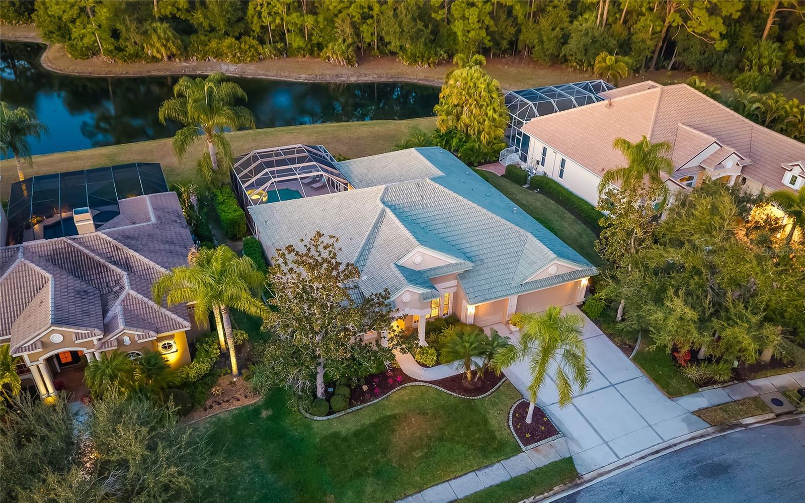 Welcome to 9515 Royal Calcutta Place, a beautifully maintained lakefront residence in The Sanctuary at River Club, where a private lake and preserve beyond set a naturally quiet, private backdrop. This established golf course community is known for its serene setting, estate homes on larger lots, and a landscape shaped by the Braden River. With ponds and waterways spanning 156 acres, River Club is defined by mature trees, protected wetlands and an unhurried sense of beauty that greets you the moment you arrive. Built in 2001 and set on a lush 0.31-acre homesite (13,660 square feet), this home features exterior upgrades for peace of mind, including hurricane shutters, irrigation, outdoor lighting and a whole-house gas generator. Inside, you’ll find 2,701 square feet under air (3,616 total), with three bedrooms and three baths, complemented by crown molding throughout, built-in features, and a freshly painted interior that feels crisp and move-in ready. River Club is home to The River Club (semi-private), where neighbors enjoy a welcoming clubhouse and social spaces, the River Club Grille and an 18-hole championship golf course designed by Ron Garl, along with a driving range, practice facilities and pro shop. Just east of Interstate 75 and off University Parkway, you’re minutes to Lakewood Ranch Main Street (2.5 miles), Publix at Town Center (2.8), UTC Mall (3.9), Sarasota Bradenton International Airport (9.9), and beaches of Lido Key (15.8). This is River Club living, peaceful, polished and effortlessly connected.