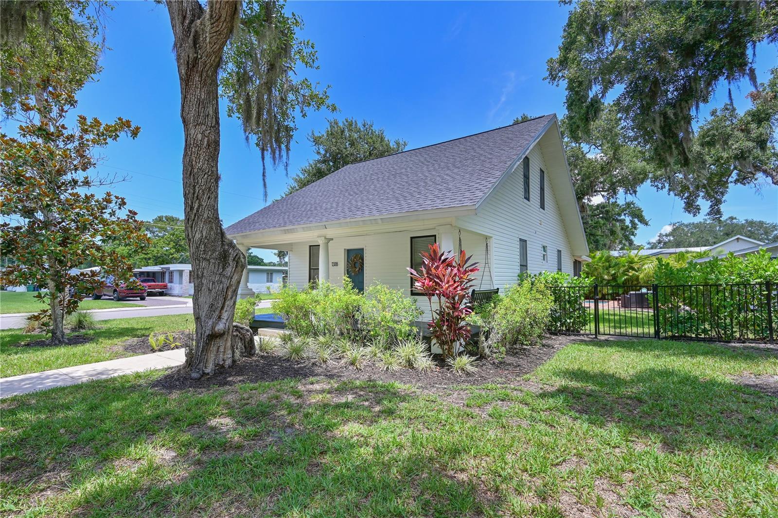 **Brand New Roof | Heated Saltwater Pool | Detached pool bath| Turnkey Opportunity** 
Welcome to this beautifully restored 1930 Florida cottage where timeless character meets thoughtful modern updates. Situated on a spacious corner lot in the heart of Palmetto, this unique property offers **2 bedrooms, 2 full baths**, including a detached pool studio bath, and has been meticulously renovated to create the perfect blend of charm, comfort, and versatility. Inside, you'll be welcomed by soaring ceilings, abundant natural light, original wood flooring, and an inviting living room. The updated kitchen showcases solid wood cabinetry, solid surface countertops, and Smeg appliances, flowing seamlessly into the living and dining areas for effortless everyday living and entertaining. Extensively updated in 2021, including the pool, kitchen, bathrooms, HVAC, electrical system, and more, this move-in-ready home also features a **brand-new roof** for added peace of mind. It has been lovingly maintained and successfully operated as a highly rated vacation rental, earning **100+ five-star reviews** and demonstrating exceptional pride of ownership.
Step outside to your own private tropical retreat. The beautifully landscaped backyard is centered around a saltwater pool with ambient lighting, creating an ideal setting for relaxing afternoons or evenings under the Florida sky. A screened porch, covered front porch, and multiple outdoor gathering spaces extend the living area and embrace Florida's year-round indoor-outdoor lifestyle. Adding exceptional flexibility, the detached studio suite with a full bath offers the perfect space for guests, a private home office, creative studio, or additional accommodations. 
Located just minutes from the Manatee River, downtown Palmetto, waterfront parks, restaurants, marinas, and with convenient access to Bradenton, St. Petersburg, Tampa, Sarasota, and the Gulf beaches, this home offers an outstanding opportunity as a primary residence, seasonal retreat, or investment property. Combining historic charm, modern updates, and an unbeatable location, this one-of-a-kind property is ready to impress from the moment you arrive.