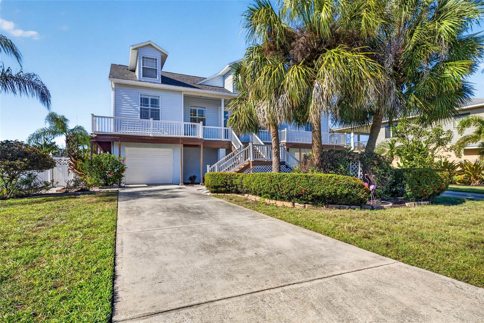 One or more photo(s) has been virtually staged. Paradise awaits you with this waterfront home and boat lift! Enjoy 79 ft of water frontage located on the Little Manatee River inlet with direct access to Tampa Bay! With no HOA or CDD, you get to enjoy the luxury of limited property restrictions saving you money! Complete with hurricane shutters, this fabulous home was built on pilings to elevate the stately residence well above sea level to provide additional protection from the occasional Florida storm and to keep the flood premiums low! From the moment you arrive, you will be greeted with double driveways that offer plenty of additional parking. A grand stairway entrance and wraparound porch with a gorgeous stained glass double door entryway welcomes you into this spacious 3 bedrooms, 2 bathroom home. As you enter the bright Great room full of windows and views of the canal you will appreciate the high ceilings, the gorgeous tile, vinyl floors, and plantation shutters that add the Florida style to this fantastic floorplan. Designed to offer privacy as well as function, the split bedroom plan places the roomy master suite on one side of the home and the two guest bedrooms and bathroom on the adjacent side. The master suite is a private escape of its own to enjoy offering views of the canal, access to the huge back patio portion of the wraparound porch as well as double master closets, an ensuite with separate vanities, a large tub, a Roman shower, and a separate water closet! When not camping out in the master, enjoy cooking in the kitchen that is nestled in the back of the home so the cook can enjoy all the beauty of the property but still be able to hide a mess if unexpected guests stopped by! There are plenty of large cabinets set off by ample tasteful Florida-style solid surface countertops. Storage in this kitchen includes a large pantry and utility closet. The washer & dryer are located in the utility closet in the kitchen but can easily be moved downstairs if preferred. On the front side of the home, you will find a dining room just off the Great room offering additional entertaining space. On the opposite side, the floorplan offers a guest bathroom and two guest rooms, one currently being used as an office with double door entry and built-in shelving offering additional storage. If work isn't on your mind anymore, the room can be easily transformed back into a bedroom. The alternate guest bedroom located at the back of the home offers views of the canal through the sliding door with access to the wrap porch. Need more space? This home has it! Downstairs you will find a palette to do as much as your imagination can create, a double garage with a total sq ft of 1597! The possibilities are endless for a home gym, game room, craft space, workshop, or anything else you can dream up. Don't forget to bring your boat! This home has a huge covered boat lift with a wraparound dock complete with power and water! Fish at night right in your own backyard or take the boat out, it's your choice at this property! For the days you don't feel like being on the water, the large fenced backyard with an expansive paver brick patio offers a fabulous place to relax or entertain. Take in the beautiful sunsets from the porch, dock, or interior of this dream property! Don't be afraid of the stairs, there is a lift! This home has it all to make your dream of waterfront living a reality! Just minutes from Bahia Beach, EG Simmons Park, and I75! This home will not last! Roof new 2025!