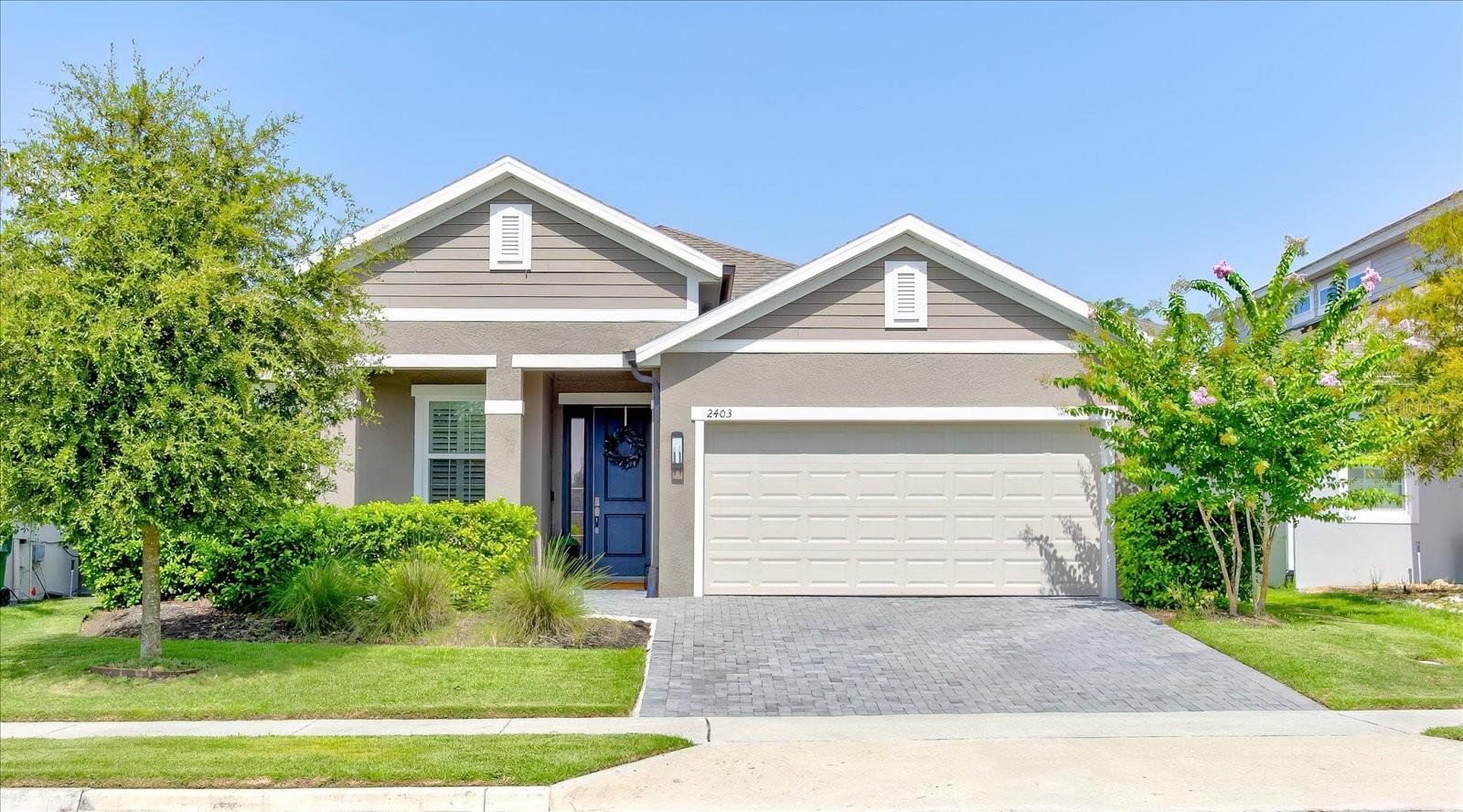 Why wait for new construction when you can move into this beautifully maintained 2022 Margate model today? This highly sought-after one-story floor plan offers nearly 2,000 square feet of thoughtfully designed living space with a desirable split-bedroom layout, open living areas, and modern upgrades throughout. From the moment you arrive, you’ll appreciate the inviting front porch overlooking rolling hills, mature trees, and the rare benefit of no direct front neighbors. Inside, this Move-In-Ready home Features elongated Tile flooring, Plantation Shutters, an extended Stone Paver Driveway, Oversized Rear Patio, Gutters with French Drains, Tankless Water Heater, and smart home features including Security Cameras and a Ring doorbell. A convenient mudroom provides the perfect drop zone, while the versatile flex room offers endless possibilities as a home office, playroom, fitness space, or additional living area. The heart of the home is the beautifully appointed kitchen featuring Quartz Countertops, solid Wood cabinetry with custom hardware, Farmhouse sink, Gas cooktop, walk-in pantry, and oversized island with bar seating—perfect for everyday living and entertaining. All appliances convey, including the newer Café refrigerator. The spacious living area showcases higher ceilings, abundant natural light, recessed lighting, and sliding glass doors leading to the extended paver lanai. The private primary suite offers tray ceilings, two walk-in closets, and a luxurious en-suite bath with dual vanities, soaking tub, tiled walk-in shower, and private water closet. Two additional bedrooms and a full bath provide comfort and privacy for family or guests. Located in the newest phase of the desirable Summerbrooke community, residents enjoy resort-style amenities including a pool, clubhouse, basketball court, and recreational areas. Just minutes from downtown Mount Dora, enjoy boutique shopping, waterfront parks, exceptional dining, and year-round festivals and events. With its modern upgrades, newer construction, desirable location, and move-in-ready condition, this home truly has it all.