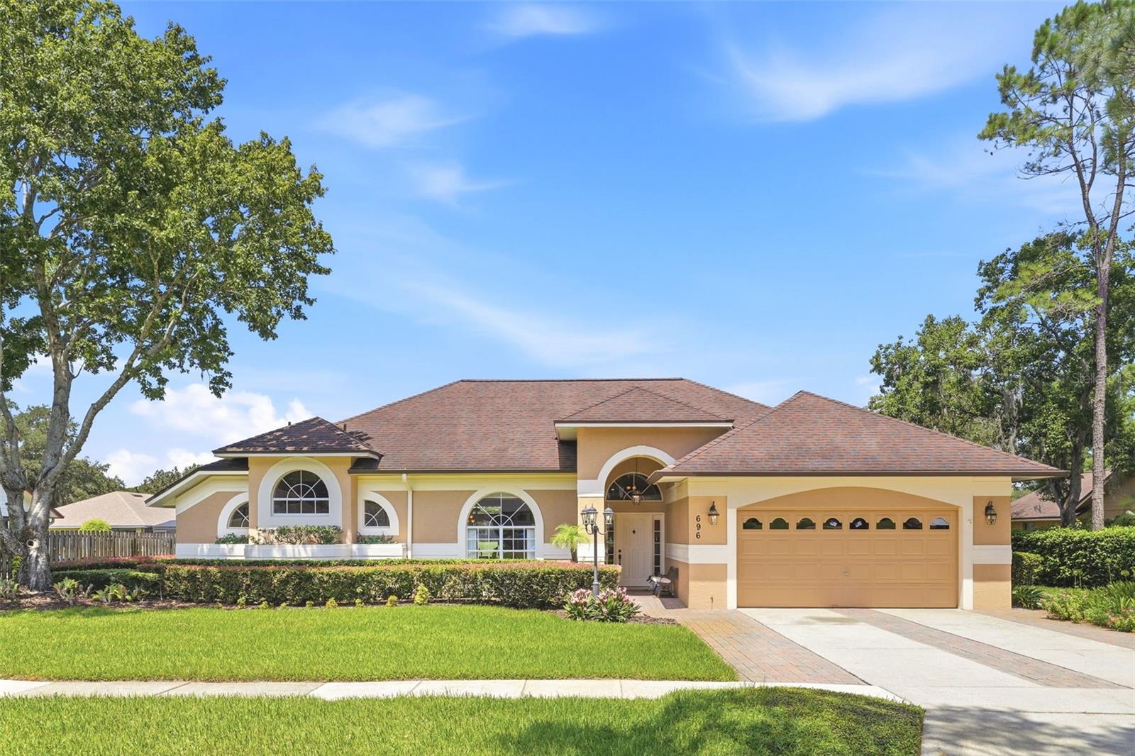 Welcome to this beautifully updated 4-bedroom, 2-bath home in the highly desirable Tuskawilla area of Winter Springs, offering picturesque views of Lake Skittles. Nestled along a charming oak tree-lined street, this home makes a lasting first impression with beautiful, mature landscaping that greets you as you arrive.

Thoughtfully maintained and upgraded, the home features new laminate flooring installed in 2023 and offers an ideal layout with separate living and dining rooms, a spacious family room, and an eat-in kitchen—perfect for both everyday living and entertaining. Architectural details throughout add character and visual interest.

The remodeled kitchen is a standout feature, showcasing custom maple cabinetry with pull-out drawers, granite countertops, and an eye-catching backsplash. Enjoy serene lake views from the kitchen, dining area, and even the primary bedroom, creating a truly unique everyday living experience.

The spacious primary suite offers dual walk-in closets with custom cabinetry and is filled with natural light from a transom window. The secondary bathroom has been fully renovated with matching custom maple cabinetry, granite counters, and an upgraded tub.

Step outside to a large screened-in porch, the perfect place to unwind and take in breathtaking sunset views over the lake. Additional highlights include an oversized 2-car garage with built-in storage, an interior laundry room with cabinetry, and major system updates including a roof (2015), HVAC (2023), and water heater (2023).

Located in a sought-after community known for top-rated schools, this home is also just minutes from shopping, dining, and everyday conveniences. A rare opportunity to enjoy lake views, thoughtful upgrades, and an unbeatable location all in one.