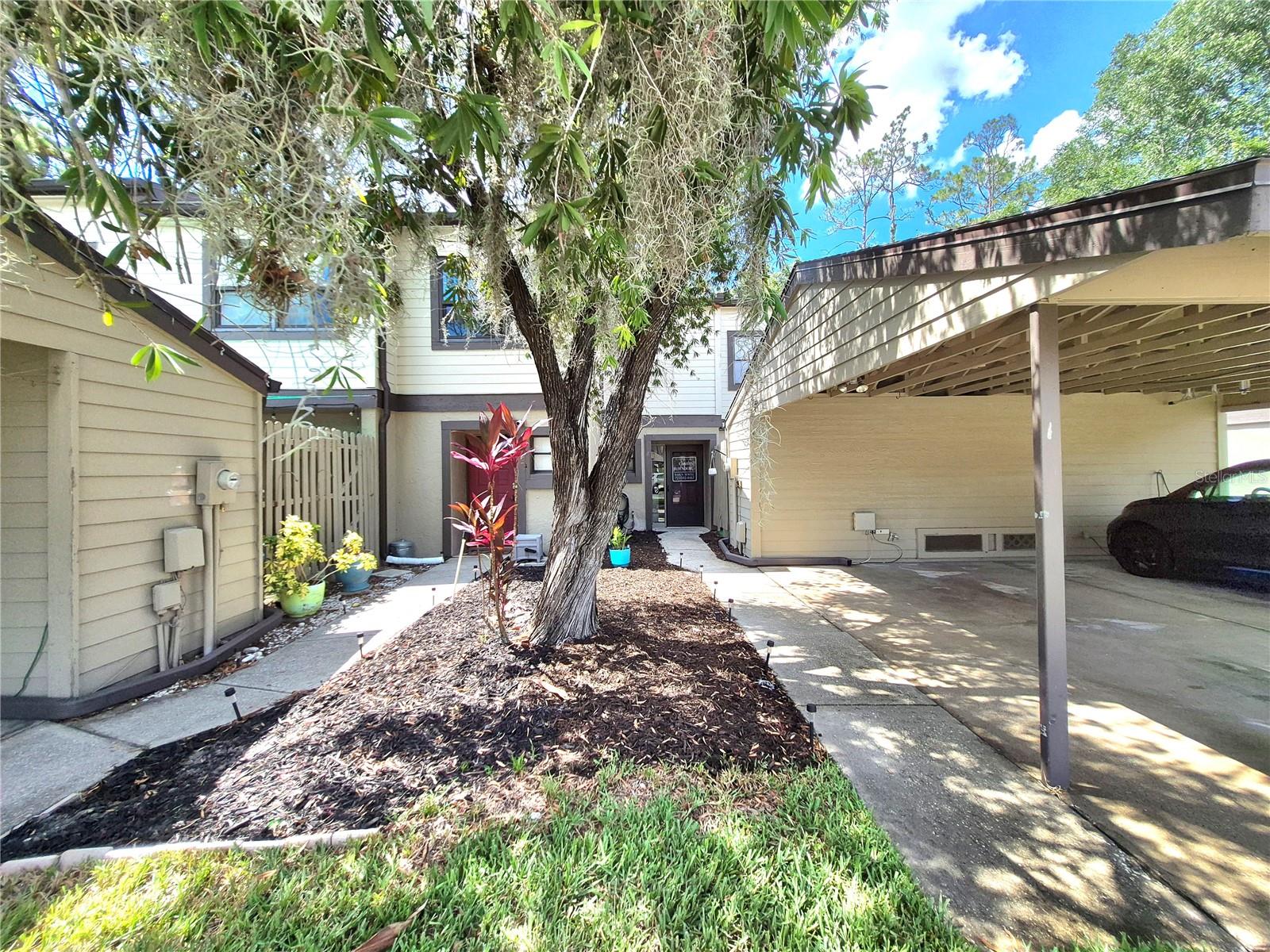 From the welcoming entrance foyer, visitors are immediately drawn to the peaceful wooded views at the rear of the home, creating a warm and inviting first impression. Welcome to this beautifully maintained two-bedroom, two-and-a-half-bath townhome in the gated community of East Lake Woodlands, one of Pinellas County's most sought-after neighborhoods. Offering maintenance-free living in a non-flood zone at an exceptional price, this home combines comfort, convenience, and value.

The spacious great room and dining area provide a versatile, open floor plan that can easily accommodate both casual everyday living and entertaining. Upstairs, two generously sized bedrooms each feature their own en-suite bathroom and walk-in closet (closets in the primary bedroom are fully customizable with the IKEA BOAXEL system), offering privacy and comfort for family members or guests. A convenient first-floor powder room adds extra functionality for everyday living and entertaining.

The bright and cheerful kitchen is filled with natural light and features a breakfast bar overlooking the dining area, a closet pantry, and sliding glass doors leading to a private front patio—an ideal spot to enjoy your morning coffee or dine outdoors. The open living and dining areas are enhanced by large windows and sliding glass doors that overlook the enclosed tiled Florida room, where you can relax while taking in tranquil wooded views and watching the local wildlife. This flexible space is perfect as a sunroom, home office, or additional entertaining area. Recently installed laminate flooring extends throughout the main level, adding both style and durability.

Additional features include a private driveway with covered carport, storage shed, and an upstairs laundry closet conveniently located between the bedrooms and equipped with a full-size washer and dryer.  The a/c in 2022 and the hw heater new in 2025.

As a resident of East Lake Woodlands, you'll have the opportunity to join the recently renovated Ardea Country Club, offering two championship 18-hole golf courses, pickleball and tennis courts, a fitness center, a full-service restaurant and bar, and an active calendar of social events. The HOA fee provides outstanding value by including roof maintenance, cable & internet at discounted rates, exterior grounds maintenance, garbage, exterior pest and termite control, exterior insurance (owner's still need to have HO6 policy) along with a community heated pool and more.

East Lake Woodlands offers the perfect balance of convenience and tranquility, with easy access to shopping, dining, beautiful Gulf beaches, Tampa International Airport, and everything the Tampa Bay area can provide—all while enjoying the charm and serenity of one of Pinellas County's premier gated communities.

Don't miss this opportunity to own an affordable home in this exclusive community and enjoy the Florida lifestyle you've been dreaming of!