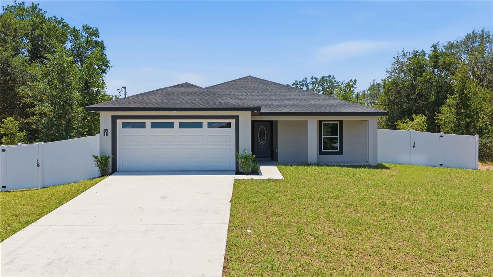 Welcome to this beautifully crafted new construction home in Silver Springs Shores, offering 3 bedrooms, 2 bathrooms, and 1,492 square feet of thoughtfully designed living space. Showcasing a sleek, modern design with high-end finishes throughout, this home perfectly blends style, comfort, and functionality. Step inside to a bright, open floor plan featuring gorgeous porcelain tile flooring throughout, creating a seamless and sophisticated look.

The spacious living room flows effortlessly into the dining area and stunning kitchen, making it perfect for both everyday living and entertaining. Designed to impress, the kitchen features stainless steel appliances, a large center island, elegant designer light fixtures, and a spacious walk-in pantry for ample storage. Sliding glass doors flood the living space with natural light.

Outside, enjoy the covered patio and spacious, fully fenced backyard, offering plenty of room for entertaining, relaxing, or letting pets play. A two-car garage adds convenience and additional storage.

The private primary suite offers a luxurious retreat, complete with a tray ceiling, a generous walk-in closet, and a beautifully appointed en-suite bathroom with dual sinks. Two additional bedrooms and a well-appointed guest bathroom provide comfortable accommodations for family, guests, or a home office.

Additional highlights include a 10-year structural warranty and a 1-year workmanship warranty, providing peace of mind for years to come. With no HOA or CDD fees, you'll enjoy even greater value and flexibility. Conveniently located in Silver Springs Shores, this exceptional home is just minutes from shopping, dining, and everyday conveniences. With its contemporary design, upscale finishes, and move-in-ready appeal, this home is the perfect combination of modern elegance and everyday comfort.