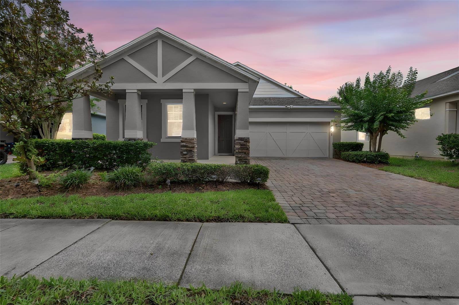 MOVE-IN READY and thoughtfully refreshed, this beautifully maintained Windermere home offers the perfect blend of comfort, functionality, and location in the highly sought-after Lake Sawyer community. Recent updates including NEW INTERIOR PAINT, NEW CARPET, NEW LIGHT FIXTURES, NEW CEILING FANS, UPDATED BATHROOM MIRRORS, a stylish KITCHEN BACKSPLASH, and an EPOXY GARAGE FLOOR create a welcoming atmosphere from the moment you arrive. As you approach the home, you'll appreciate the attractive curb appeal, covered front entry, and mature landscaping. Step inside and you're greeted by a bright, open layout enhanced by elegant archways, abundant natural light, and durable tile flooring throughout the main living areas. The thoughtful floor plan creates a seamless flow between the living room, dining area, and kitchen, making everyday living and entertaining feel effortless. At the heart of the home, the kitchen offers granite countertops, rich wood cabinetry, stainless steel appliances, a spacious center island, and a newly installed backsplash that adds a fresh, modern touch. Whether preparing meals, gathering with family, or hosting guests, this space is designed to keep everyone connected. The spacious living area overlooks the backyard and provides a comfortable setting for relaxing or entertaining. Just beyond, sliding glass doors lead to the covered lanai where you can enjoy morning coffee, outdoor dining, or quiet evenings overlooking the FENCED YARD. The private primary suite is tucked away from the secondary bedrooms, creating a peaceful retreat at the end of the day. This spacious owner's suite features a walk-in closet and an ensuite bath complete with dual vanities and a glass-enclosed shower. The split-bedroom layout provides privacy for family members and guests alike. Three additional bedrooms provide flexibility for growing households, guests, remote work, hobbies, or multigenerational living. One room is currently utilized as a prayer room and can easily serve as a home office, study, fitness space, or creative flex room. The secondary bathrooms have been refreshed with new mirrors, contributing to the home's updated appearance. Additional highlights include an interior laundry room, ample storage throughout, a two-car garage featuring a professionally finished epoxy floor, irrigation system, and numerous cosmetic improvements that allow the next owner to move in and immediately begin enjoying the home. Located in the desirable Lake Sawyer community, residents enjoy access to a community pool, playground, park, and sidewalks. The home is zoned for highly rated Sunset Park Elementary, Horizon West Middle School, and Windermere High School. Conveniently situated near Horizon West, Hamlin Town Center, shopping, dining, major roadways, and many of Central Florida's most popular attractions, this location offers easy access to Disney, Disney Springs, and the greater Orlando area. Whether you're searching for Orlando homes for sale, a Central Florida real estate opportunity, or an Orlando relocation home in one of Windermere's most desirable communities, this property offers exceptional value and convenience.