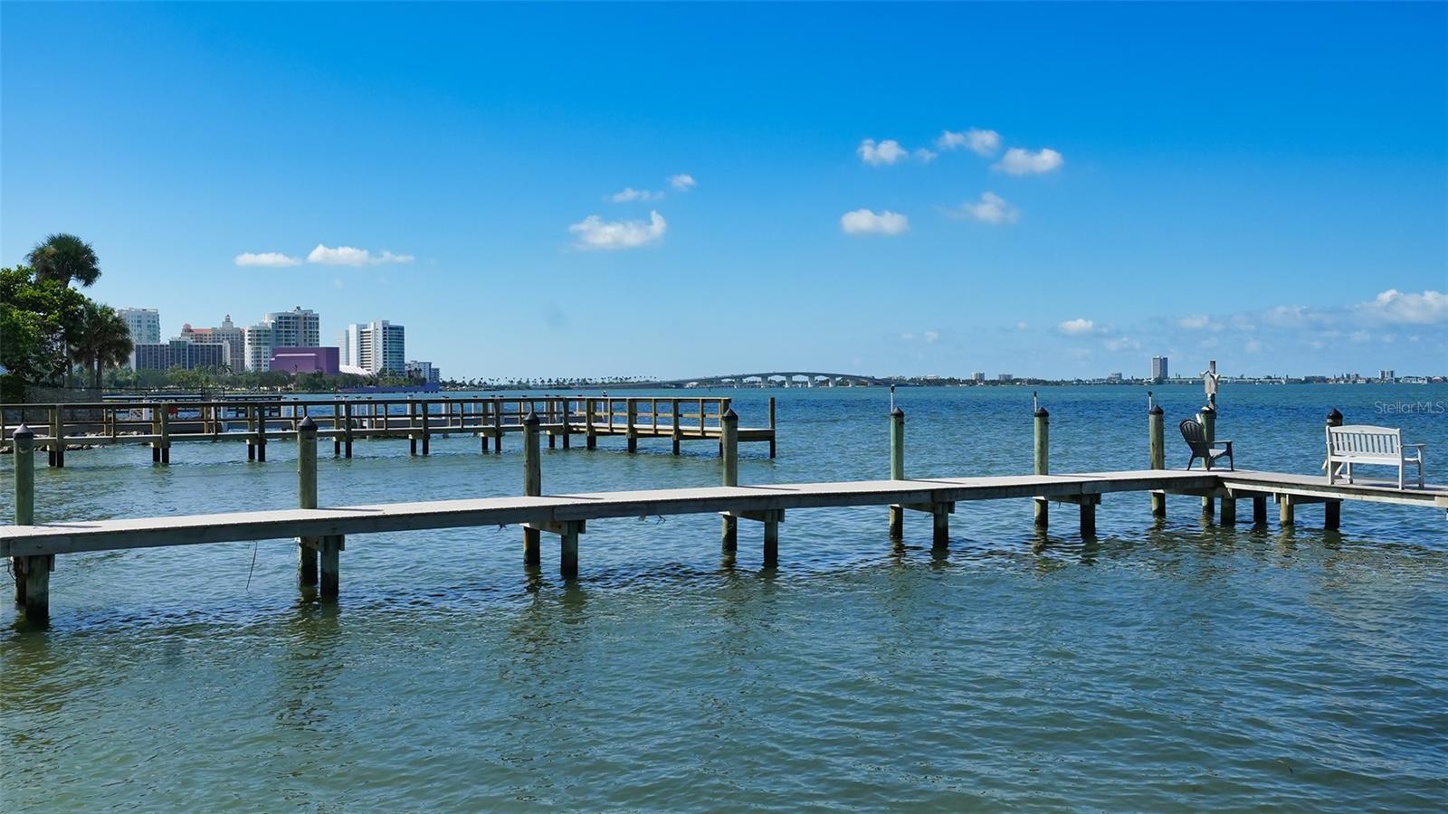 Situated on nearly an acre of prime waterfront land, this property offers sweeping breathtaking vistas of Sarasota Bay and the City skyline. 
Just minutes away from downtown Sarasota, the approach to this estate is graced by a lush canopy of trees and tropical foliage. While the current residence is suitable for immediate occupancy, it also presents an incredible opportunity for those contemplating the construction of a new home. The layout of the existing home includes a living room, family room/library, kitchen, and formal dining room on the main level. A screened lanai overlooks the saltwater pool. Upstairs, you'll find three bedrooms and 3 ½ baths, complemented by a generously sized enclosed lanai located just off the oversized Primary suite, that provides unparalleled views. Other notable features include a grand two story entryway, ample storage space, floor-to-ceiling built-in bookshelves, an abundance of windows and sliding doors that flood the interior with natural light. For those with nautical aspirations, we are pleased to inform you that the owner consulted with a dock company and has been advised that a dock can be added to this property. The process requires the new homeowner to obtain all necessary permits for construction and enlist a licensed contractor to oversee the project. Welcome to a hidden slice of paradise, only a stone’s throw to all of the hot spots in downtown Sarasota.