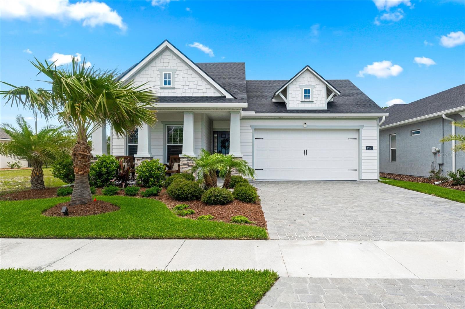 Welcome to 257 Mosaic Blvd, Daytona Beach, FL 32124  a like-new 3-bedroom, 2-bathroom home in the highly desirable Mosaic community! Designed with comfort and style in mind, this home features a spacious split-bedroom floorplan, high ceilings, and an open-concept layout perfect for everyday living and entertaining.

Step inside to the bright and inviting main living area where the living room, dining area, and kitchen flow seamlessly together. Sliding glass doors and transom windows fill the space with natural light, creating an airy and welcoming atmosphere. The kitchen is a standout, featuring a built-in oven, cooktop, ample counter space, and a center island with additional seating.

Tucked away at the back of the home for added privacy, the spacious primary suite offers a tray ceiling, walk-in closet, and an ensuite bathroom with double vanity sinks and a separate shower. Toward the front of the home, two additional bedrooms share a full bathroom, providing plenty of space for family or guests.

Enjoy outdoor living in the screened paver patio overlooking the fenced backyard, complete with an extended patio and plenty of space to relax, entertain, or enjoy the Florida sunshine.

Mosaic offers fantastic community amenities including a pool and playground. Conveniently located near I-4 and I-95, you’ll enjoy easy access to Tanger Outlets Daytona Beach, Daytona Beach beaches, Ormond Beach beaches, Daytona Beach International Airport, Daytona International Speedway, shopping, dining, and the renowned LPGA golf courses just across the street.

Don’t miss your opportunity to own this beautiful home in an amazing community!