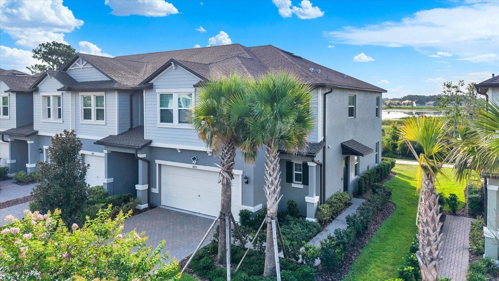 Welcome to this stunning 2023-built end-unit townhome in the award-winning Connerton community of Land O’ Lakes. This beautifully maintained home offers 3 bedrooms, 2.5 baths, a spacious loft, and a 2-car garage, all overlooking a peaceful pond view. The open-concept layout features a modern kitchen with granite countertops, a large pantry, a center island, and bright living spaces with contemporary finishes throughout. Upstairs, the primary suite includes a California closet-style walk-in closet, a dual-vanity bathroom, and a walk-in shower, creating a comfortable and functional retreat. The garage is fully upgraded with epoxy flooring, a built-in workbench, a generator hookup, and a water softener, valuable features that add convenience and peace of mind. A transferable structural warranty provides long-term confidence for the next owner. Enjoy low-maintenance living with a low HOA of just $304.09/month, which includes high-speed internet and a router. Connerton is known for its resort-style amenities, including a community pool, clubhouse, fitness center, splash park, multiple playgrounds, sports courts, dog park, and miles of walking and biking trails throughout this nature-focused master-planned community. Just outside the subdivision you’ll find local restaurants, Publix, Walgreens, and convenient shopping. Perfectly located approximately 8 miles, about 15 minutes, to Tampa Premium Outlets and roughly 28 miles, about 35–40 minutes, to Tampa International Airport, offering quick access to premier shopping, dining, and travel. This move-in-ready home blends modern comfort, community living, and an unbeatable location. A must-see for today’s buyers.