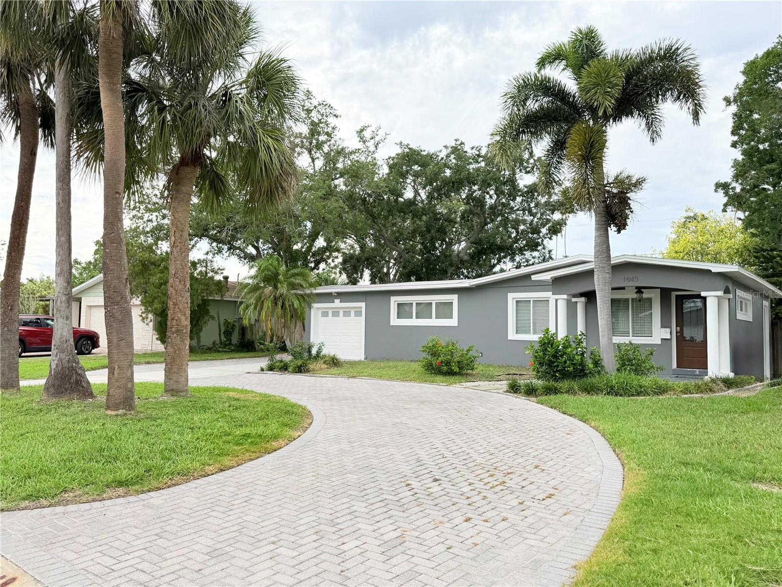 Welcome home to this beautiful, move-in-ready 3-bedroom, 2-bathroom ranch-style home located in the quiet and highly sought-after Shore Acres neighborhood of Northeast St. Petersburg!
Step inside to find a bright, open living space featuring low-maintenance, modern ceramic tile flooring throughout—no carpet here! The functional layout offers a spacious primary bedroom, a comfortable living room, and a fully equipped kitchen. Enjoy modern conveniences including central heating/air conditioning, an inside laundry area, and a tankless water heater for endless hot water.
Outside, the property boasts a massive 8,237 sq. ft. lot with a circular driveway for easy parking, plus an attached 1-car garage for extra storage or parking. Located just minutes from vibrant downtown St. Pete, local boat ramps, parks, and top-rated area schools (Shore Acres Elementary, Meadowlawn Middle, Northeast High), this home offers the perfect balance of peaceful neighborhood living and city convenience.