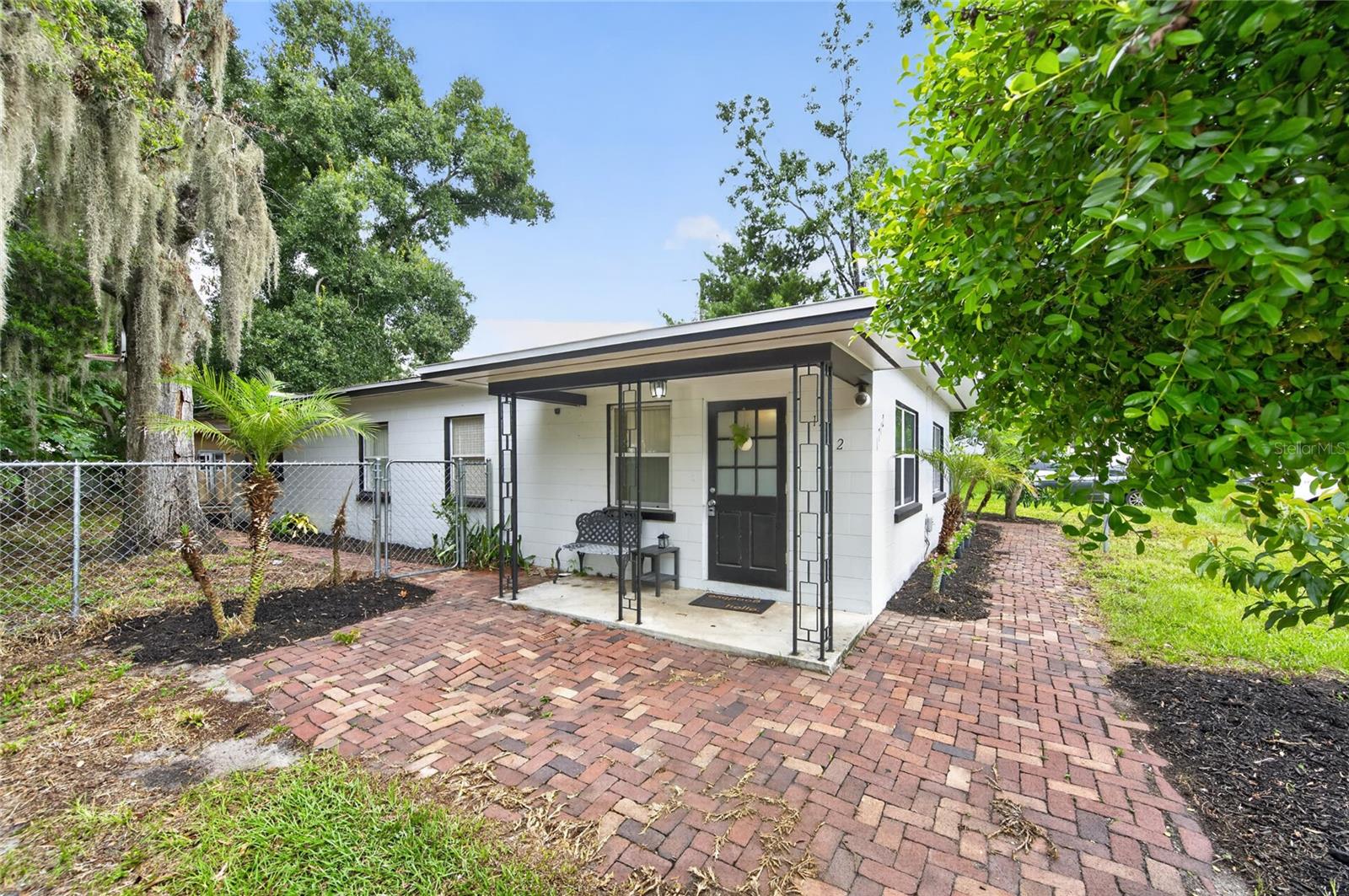 Welcome home to this beautifully maintained 4-bedroom, 2-bath residence offering comfort, style, and a convenient Central Florida location. Warm, earthy tones and abundant natural light create a welcoming atmosphere throughout the home. The spacious living room flows seamlessly into the large dining area, making it ideal for both everyday living and entertaining. The updated kitchen features solid wood cabinetry, a closet pantry, and a stainless steel appliance package, providing both functionality and timeless appeal. A generously sized laundry/utility room includes a washer and dryer, adding extra convenience. You'll appreciate the thoughtful upgrades throughout the home, including tile flooring throughout, ceiling fans, upgraded light fixtures, stylish door hardware, and fresh interior and exterior paint. Major updates include a new roof and A/C installed in 2018, offering added peace of mind. Situated on a desirable corner lot, the fully fenced yard provides privacy and plenty of space to enjoy the outdoors. Mature oak trees offer refreshing shade, while the mango and avocado trees add a tropical touch. A charming brick paver sidewalk wraps around the home, enhancing its curb appeal. Conveniently located with easy access to Highway 27 and I-4, this home is just minutes from medical facilities, shopping, grocery stores, restaurants, and entertainment. Whether you're looking for your first home, a place to grow, or an investment opportunity, this move-in-ready property is one you won't want to miss!
