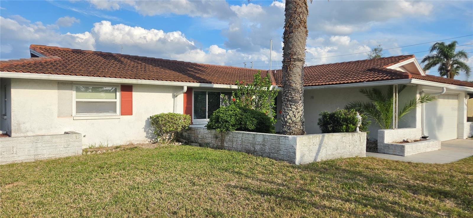One of the last flood homes that has not been rehabilitated—priced to sell! Rare opportunity to create your dream waterfront home in desirable Flor-A-Mar at Gulf Harbors. This 2-bedroom, 2-bath, 2-car garage home offers 80 feet of seawall on a deep, wide canal with quick Gulf access just minutes to open water. Enjoy beautiful water views, boating, fishing, dolphins, and manatees right from your backyard. Drywall has already been removed following Hurricane Helene, giving you a head start on renovations. Optional HOA and private beach club membership available. Sold As-Is. Cash or renovation financing recommended.
