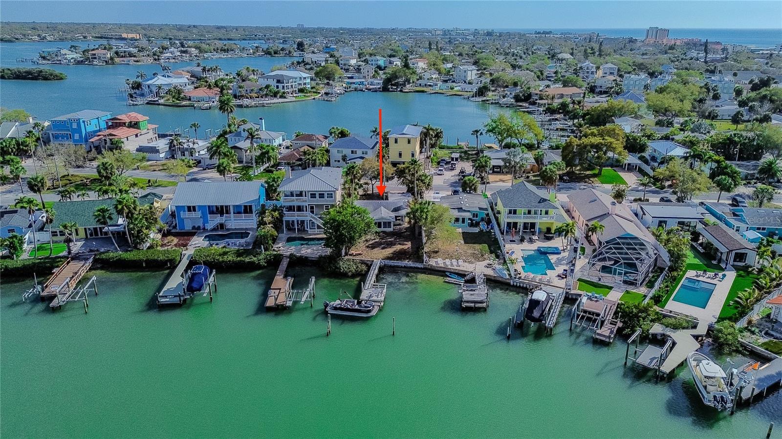 Incredible opportunity under $1mm.  Charming waterfront Indian Rocks Beach (IRB) Cottage priced to sell!  Nestled at the southern apex of coveted Dolphin Bay on the Intracoastal and just three blocks from the open Gulf.  With 27 beach access points in Indian Rocks Beach, this property offers an exceptional opportunity to enjoy waterfront living in one of the area’s most beloved coastal communities. The updated home features two bedrooms, one full bathroom with plenty of room to add on. Thoughtfully maintained and recently refreshed with approximately $80,000 in improvements, the home blends comfortable living with the charm of classic Florida waterfront properties. Inside, the updated kitchen offers stainless steel appliances, subway tile backsplash, modern cabinetry, and a breakfast bar that opens to the living spaces, creating an easy flow for everyday living. The bathroom has been tastefully renovated with coastal-inspired finishes, while large windows throughout the home bring in natural light and highlight the beautiful water views beyond. A spacious waterfront sunroom quickly becomes the heart of the home, framed by expansive windows that showcase the open water Intracoastal and create a relaxing place to unwind while watching boats pass by and marine life surface. Outside, the property continues to shine with nearly 50 linear feet of seawall and a 47 foot dock extending out to approximately 7 feet of draft at median high tide. Moorings are already in place to accommodate sailboats and cruisers, making it easy to bring your deep water vessel and explore the waterways right from your backyard. Natural mangroves along the shoreline create a protected habitat that attracts abundant sea life including dolphin, manatee, sea birds, and world class inshore sport fish. Spend your days water skiing, tubing, paddle boarding, or simply enjoying peaceful sunrise views over the bay. From here, sunset cruises, waterfront dining, relaxing spoil islands, and the open Gulf are all just a short boat ride away. Indian Rocks Beach remains one of the Gulf Coast’s most cherished small beach towns, known for its welcoming atmosphere and community spirit. Local seafood restaurants, surf shops, parks, art center, community garden, baseball field, and shopping are all nearby, with golf cart friendly streets making it easy to get around. Festivals and events are held throughout the year, creating a vibrant coastal lifestyle. Convenient access to two international airports and professional sports venues for the Rays, Buccaneers, Rowdies, and Lightning adds to the appeal. Whether you choose to enjoy the existing home, renovate further, or design a future waterfront retreat, opportunities like this rarely come along. Welcome to Indian Rocks Beach!