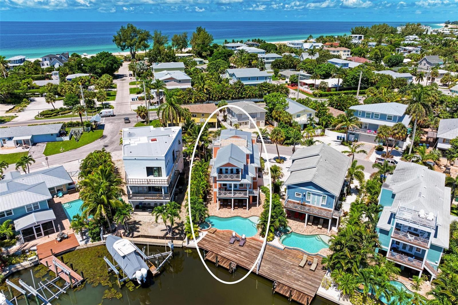 Your dream view, just got a dream price!  Luxury 5 Bedroom Waterfront + Dock | 3-Min Walk to Beach -Exceptional waterfront retreat perfectly positioned in the heart of Anna Maria Island. Just a three-minute stroll to the soft sugar sands of Manatee Beach, this stunning five-bedroom, three-and-a-half-bath residence delivers coastal luxury at every turn—complete with a private dock with ladder where manatees often glide by, a heated pool and spa, and a show-stopping rooftop deck with Gulf and Bay views.
Designed for unforgettable gatherings, Coral Castle seamlessly blends upscale comfort with relaxed island charm! Outdoor Living at Its Finest, the rooftop deck is the crown jewel of Coral Castle—offering breathtaking sunrise and sunset views over both the Gulf and Bay. Start your mornings with coffee and ocean breezes or unwind in the evening with a cocktail as the sky glows in brilliant island hues.
The tropical backyard is a private sanctuary featuring a heated pool, spa, lounge seating, and outdoor grill, perfect for post-beach relaxation or entertaining under the stars. From the private dock, enjoy peaceful water views—and keep watch for friendly manatees passing by, an unforgettable hallmark of island living.

Stylish Interiors Made for Comfort-Step inside to a bright, open-concept living space filled with natural light and coastal elegance. The living room offers plush seating, a flat-screen TV, and sliding glass doors that open directly to the outdoor patio—blurring the line between indoor and outdoor living.
The chef-inspired kitchen is fully equipped with stainless steel appliances, generous counter space, and a wine fridge, making meal prep effortless. Gather inside at the dining table or dine alfresco beneath the covered patio for a true island experience.
Sleep in Luxury-
Primary Suite: King bed, private balcony, vaulted shiplap ceiling, walk-in closet, spa-style ensuite with soaking tub and walk-in shower; Second Bedroom: King bed, Jack-and-Jill bathroom with walk-in shower; Third Bedroom: King bed, Jack-and-Jill bathroom with walk-in shower; Fourth Bedroom: Full bed, Jack-and-Jill bathroom with shower/tub combo; and Fifth Bedroom: Full bed, Jack-and-Jill bathroom with shower/tub combo.
Prime Island Location- Enjoy peaceful mornings fishing from the dock or take a short drive to Pine Avenue and Bridge Street, where you’ll discover charming boutiques, local dining, and island favorites. Whether your days are spent boating, lounging by the pool, or soaking in rooftop views, Coral Castle delivers the perfect balance of relaxation and adventure. Every detail is designed to create lasting memories—from manatee sightings to sunset cocktails on the rooftop. This is more than a stay—it’s a true Anna Maria Island experience.
Currently operating as a vacation rental with solid history and a strong start to 2026—ideal personal-use + income opportunity.