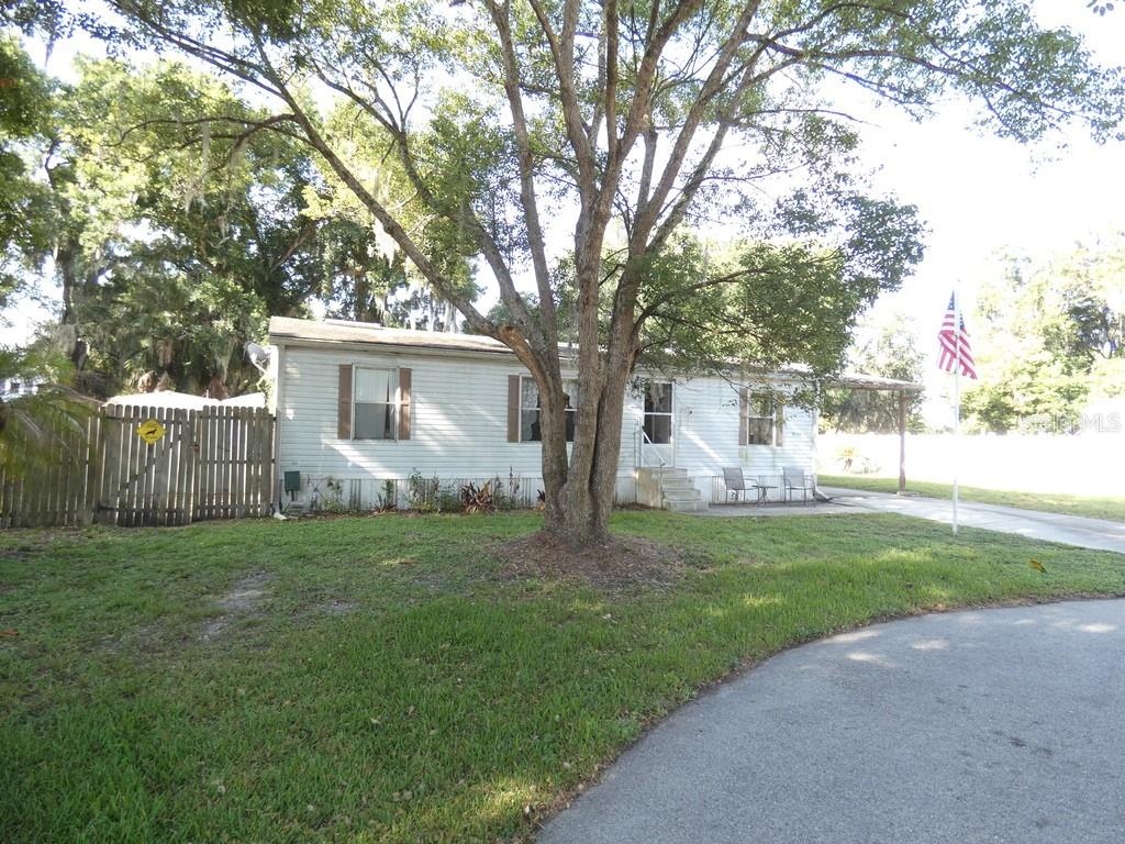 This property sits in a very quiet cul-de-sac. Power lines below the ground. Truly a setting for true relaxation. Almost zero drive-by. This is an up-and-coming area.  No HOA, NO CDD, NON FLOOD ZONE PER THE COUNTY, Homes behind this one are easily $500,000 plus. The lot alone has tremendous value. This double wide manufactured home has been loved for a long time. If you desire true peace and quiet, this is a must to come look at, I believe when it sells there will be other buyers that will be sad that they didn't get it. Must Check this out if you want (PEACE And QUIET)