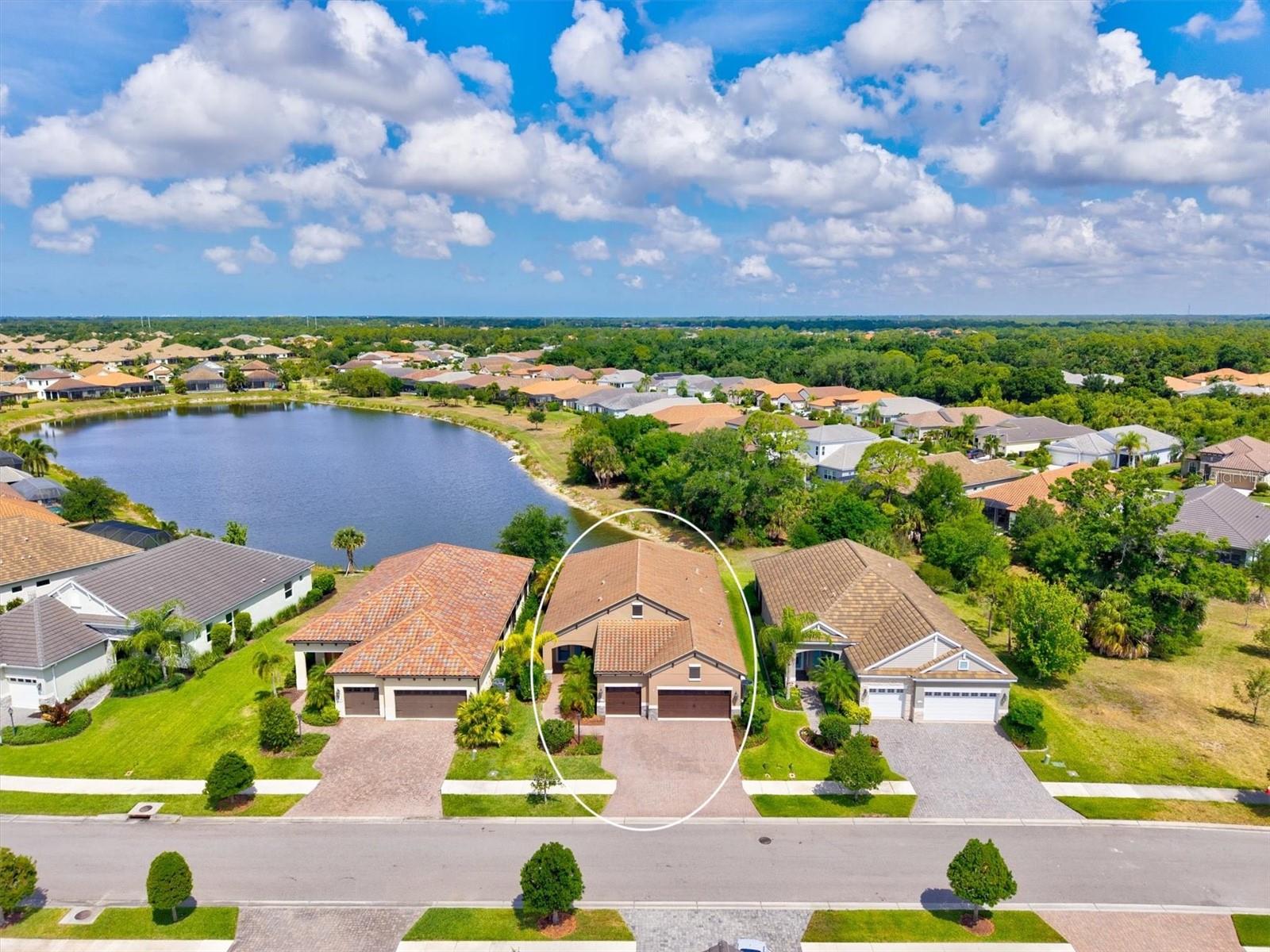 One or more photo(s) has been virtually staged. This beautifully upgraded Sea Mist model in Grand Palm delivers the perfect blend of luxury, privacy, and effortless Florida living. Set on a premium homesite, the home enjoys long water views with a preserve alongside. The extended lanai features SPF screens and sealed pavers.
A standout feature is the extended three-car garage with a four-foot extension, providing exceptional space and versatility. It is fully equipped with insulated doors, attic insulation, a built-in workbench and a mini split system.
Inside, the front glass entry door allows for a bright open layout. The kitchen impresses with glass-front cabinetry, a wood-paneled island, a California Closet pantry, stainless steel appliances and reverse osmosis system. The primary suite is a true retreat, featuring a tray ceiling, sweeping water views, dual walk-in closets with California Closet systems, and a spa-like bath with dual sinks and a spacious walk-in shower along with additional built-in shelving in the private water closet. The guest bedroom also offers a walk-in closet with California Closet shelving. A true highlight is the custom built-in office with engineered wood flooring, designed for productivity and style, paired with an oversized laundry room offering exceptional cabinetry and storage that elevates everyday living.
Additional upgrades include long plank tile flooring, custom draperies, added half bath, added linen closet shelving, whole-house EcoWater system and fresh exterior paint—making this home truly move-in ready.
Residents of Grand Palm enjoy an amenity-rich lifestyle surrounded 1000 acres, approximately 330 acres of preserved lakes, wetlands, and natural habitat, with trails and wildlife corridors woven throughout the community. A full-time activities director coordinates year-round events, clubs, fitness classes, and social programming, including pickleball, creating a true resort-style atmosphere.
Ideally located just minutes from I-75 for easy commuting and the vibrant shops, dining, and entertainment of Wellen Park, this home offers unmatched convenience alongside its serene natural setting.