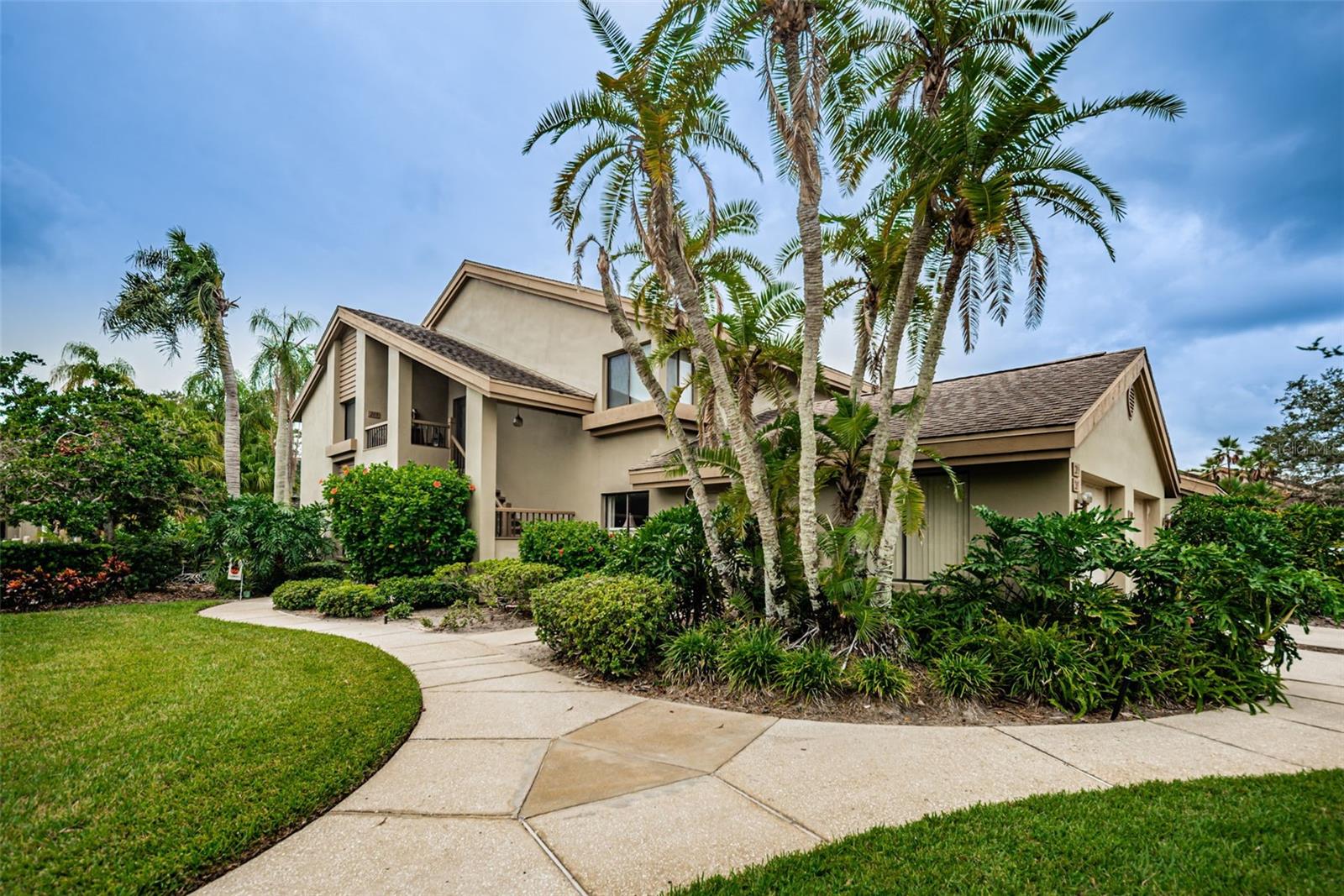 DON'T MISS THIS ONE- Pride of ownership shows in this spacious 2nd floor corner unit features 3 bedrooms 2 bathrooms, a wood burning fireplace, and a 1 car garage. Overlooking the sparkling community pool, this WELL MAINTAINED unit has a new hot water heater and newer AC. Featuring vaulted ceilings, you'll feel the spaciousness of the split floor plan as you enter.  The living and dining rooms with new wood laminate flooring, combine to make a perfect place to gather friends and family for holidays or just hanging out. There's also a double Casablanca fan and dry bar. The remodeled kitchen has solid maple wood cabinetry, tiled backsplash, Corian countertops, white appliances  and a sunny garden window with lots of storage space and a cozy breakfast nook. The 3 season balcony has new sliding vinyl windows, a Jenn Air grill and small refrigerator -  a perfect place to relax and enjoy the Florida lifestyle. The spacious master retreat has new carpet ( Jan 2023) and features a comfortable sitting area, walk-in closet, large vanity for storage, a step in shower and a separate toilet room.  Your family and guests will be comfortable in the other two bedrooms, one with new carpet, large closet and the third has a walk-in closet and is currently used as an office. There's a convenient laundry room as well. The community has a tennis court, a pavilion and plenty of guest parking.  Landmark Oaks is literally minutes from TPA, great beaches, restaurants, shopping and entertainment in all directions.