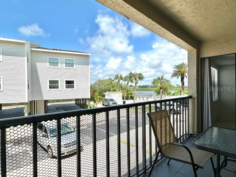 A rare opportunity to own an updated, income-producing condo in the highly sought-after Sea Club Resort, just steps from the white sands of Indian Shores Beach! This spacious 2-bedroom, 2-bath residence offers 1,285 square feet of living space, one of the larger floor plans in the community, and has been thoughtfully updated throughout, creating a true turnkey experience for both owners and guests. The open-concept layout is filled with natural light. It flows seamlessly to a private balcony where you can enjoy partial water views, an uncommon and highly desirable feature within the complex. The generously sized bedrooms comfortably accommodate six or more guests, enhancing the rental appeal. With weekly rentals permitted and strong demand in the area, this property presents excellent income potential while still offering flexibility for personal use as a primary residence, second home, or vacation getaway. Sea Club Resort is a well-maintained waterfront community along the Intracoastal Waterway offering resort-style amenities, including a large heated pool, fishing pier, grilling stations, picnic areas, and lush green space, all within walking distance to local restaurants, shops, and entertainment. Combining size, upgrades, location, and rental flexibility, this is a standout coastal investment in one of the Gulf Coast’s most desirable beach communities.