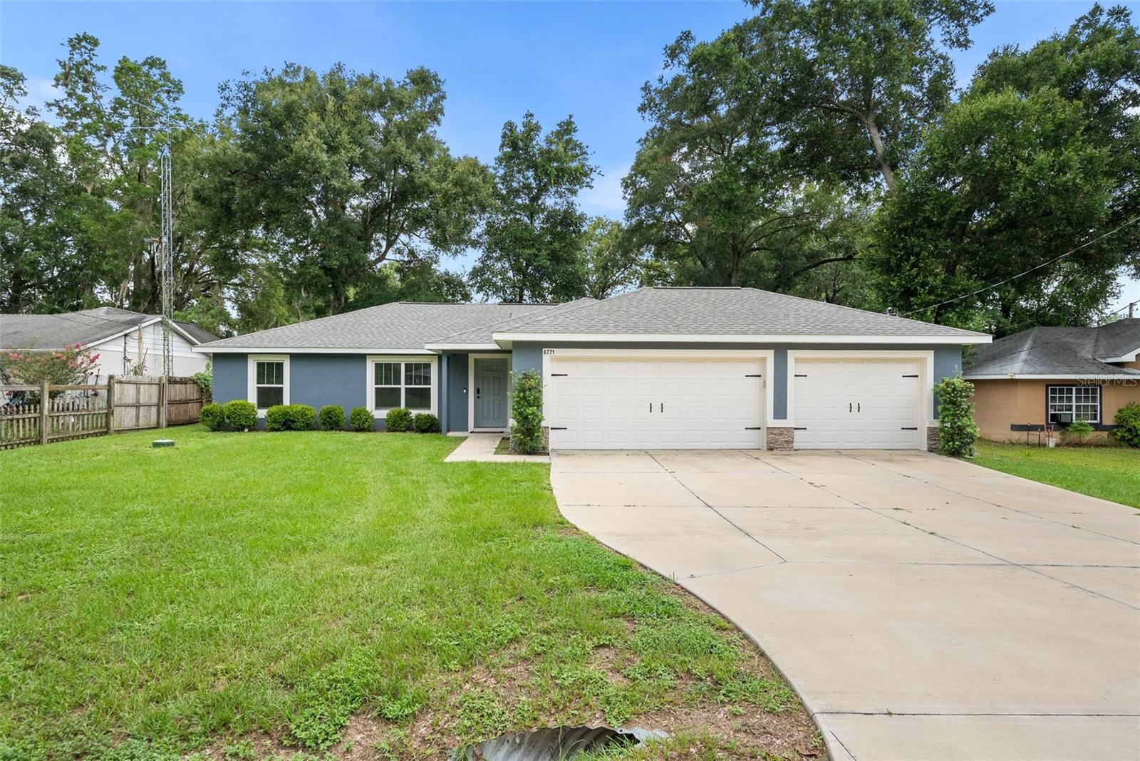 Built in 2022, this beautifully maintained 3 bedroom, 2 bathroom home offers the perfect combination of modern style, thoughtful design, and everyday functionality. Step inside to an open floor plan highlighted by soaring vaulted ceilings, abundant natural light, and luxury vinyl plank flooring throughout. The kitchen serves as the heart of the home with granite countertops, stainless steel appliances, white shaker cabinetry, a large center island, and plenty of space for both cooking and gathering. The split bedroom layout provides privacy for the spacious primary suite, complete with dual vanities and an oversized walk in closet, while the guest bedrooms are tucked away on the opposite side of the home. Step outside and you'll immediately appreciate one of this home's standout features, a massive covered back porch overlooking the fully fenced backyard. Whether you're hosting football Saturdays, grilling with friends, or simply enjoying a quiet evening outdoors, this space is ready for it all. A rare three car garage provides exceptional room for vehicles, tools, storage, or recreational equipment, an amenity that's hard to find in this neighborhood. With no HOA, quality construction, and a convenient Ocala location, this move in ready home offers the features today's buyers have been searching for.
