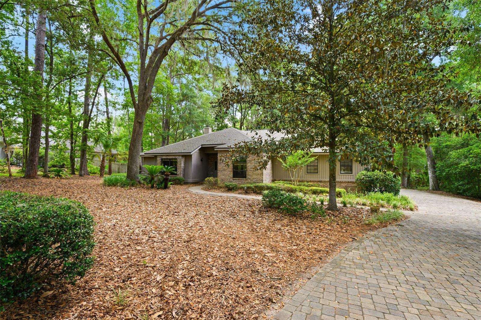 Tucked away on a private ¾-acre cul-de-sac lot in The Preserve at Haile Plantation, this beautifully updated 4-bedroom, 2.5-bath pool home offers the perfect combination of privacy, luxury, and an active community lifestyle. From the moment you arrive, the home's timeless curb appeal shines with warm brick accents and a fully brick-paver driveway. Inside, you will find over 70K in updates, including brand-new luxury vinyl plank flooring throughout, new carpet in the bedrooms, a completely renovated guest bathroom, new interior paint, newer roof, newer water heaters, and an updated kitchen, making this home truly move-in ready. Designed for both everyday living and entertaining, the spacious floor plan features a welcoming foyer, formal dining room, private office with double pocket doors, and an impressive great room with soaring cathedral ceilings, a dramatic brick fireplace flanked by built-ins, and expansive windows and French doors overlooking the pool. The updated kitchen is the heart of the home, featuring solid wood cabinetry, granite countertops, decorative tile backsplash, stainless steel appliances including a gas cooktop, French-door refrigerator, breakfast bar, and a sunny breakfast nook with beautiful pool views. Privately tucked away from the guest bedrooms, the spacious owner's suite is a true retreat with pool views, crown molding, dual walk-in closets, and a luxurious spa-inspired bath complete with a jetted soaking tub, walk-in shower, private water closet, and oversized granite dual vanity. Three generously sized guest bedrooms share a beautifully remodeled bathroom, while an updated half bath is conveniently located near the office for guests. Step outside to your own backyard oasis. The expansive brick-paver lanai offers plenty of covered space for relaxing or entertaining while overlooking the heated pool and spa, all enclosed within a newer screened enclosure. Surrounded by mature landscaping and a private backyard, this peaceful setting also provides direct access to a scenic neighborhood walking trail just beyond the property. Additional features include an oversized two-car garage and an indoor laundry room complete with washer and dryer. Residents of Haile Plantation enjoy access to miles of walking and biking trails, a charming village center filled with restaurants and shops, top-rated schools, and the opportunity to join Hawkstone Country Club for golf, tennis, swimming, fitness, and dining. Rarely do homes combine this level of privacy, extensive updates, resort-style outdoor living, and exceptional community amenities. Schedule your private showing today and experience everything this exceptional Haile Plantation home has to offer.