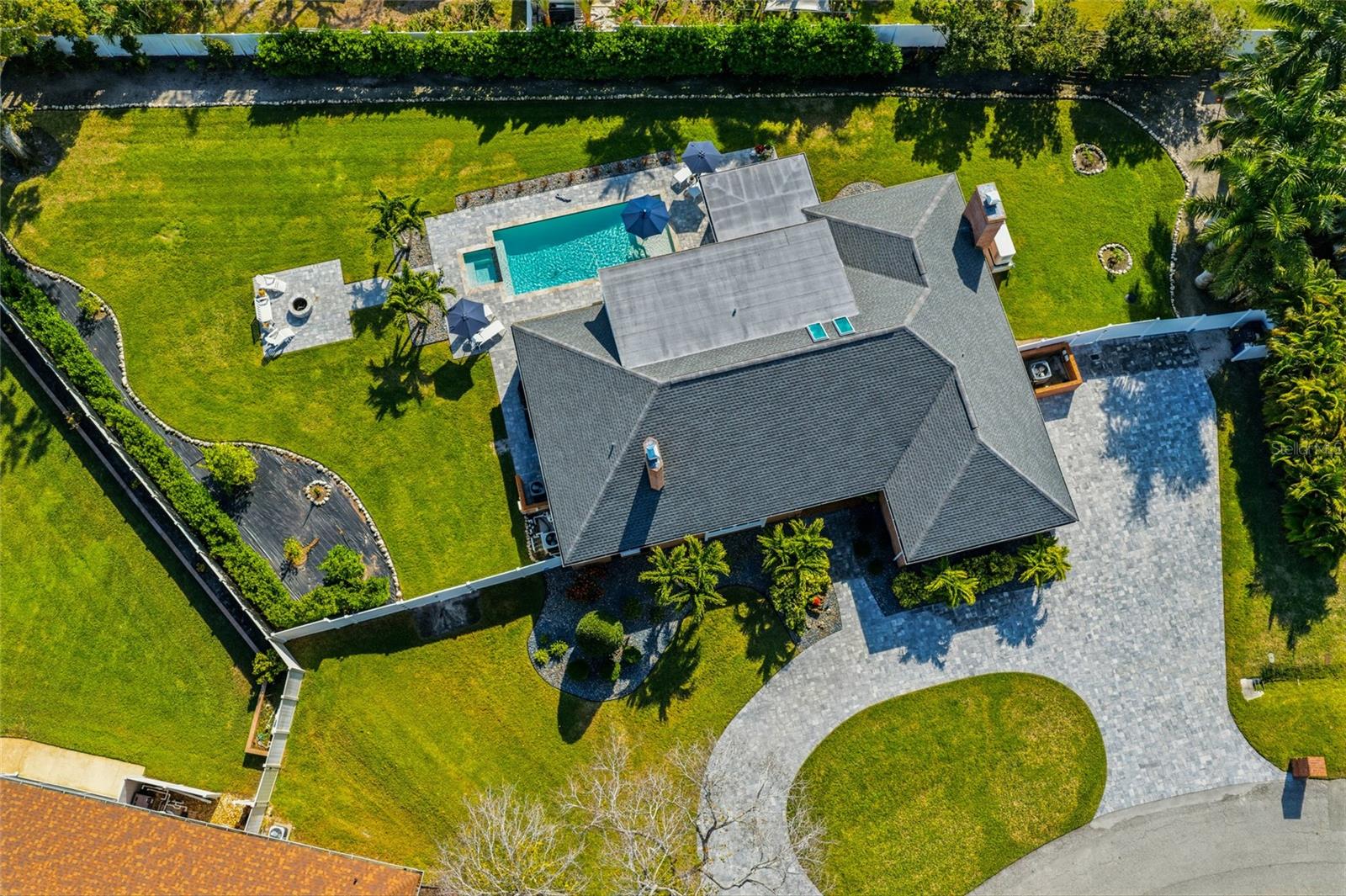 Welcome to 1307 Riverview Circle in northwest Bradenton, a beautifully updated and exceptionally well-appointed residence offering luxury and comfort, on an oversized 26,272-square-foot lot. With 4,377 square feet under roof, this spacious residence features four bedrooms and five baths, ideal for everyday living and entertaining. The home offers a formal living room and a large family room, each enhanced by its fireplace, creating warm and inviting gathering spaces. Recent upgrades include a new 32-kilowatt Generac cool gel whole-house generator with a 500-gallon propane tank, a new roof and all-new impact-rated windows throughout. The gourmet kitchen is equipped with premium Thermador appliances and flows seamlessly into the main living areas. Step outside to your private backyard oasis with a sparkling pool and spa, fire pit, expansive paver decking and lush tropical landscaping highlighted by fruit trees, including lemon, lime, orange and avocado. Designed for effortless indoor-outdoor living, this exceptional property offers elegance and functionality in a prime northwest Bradenton location close to beaches, shopping, dining and all the Florida lifestyle has to offer.