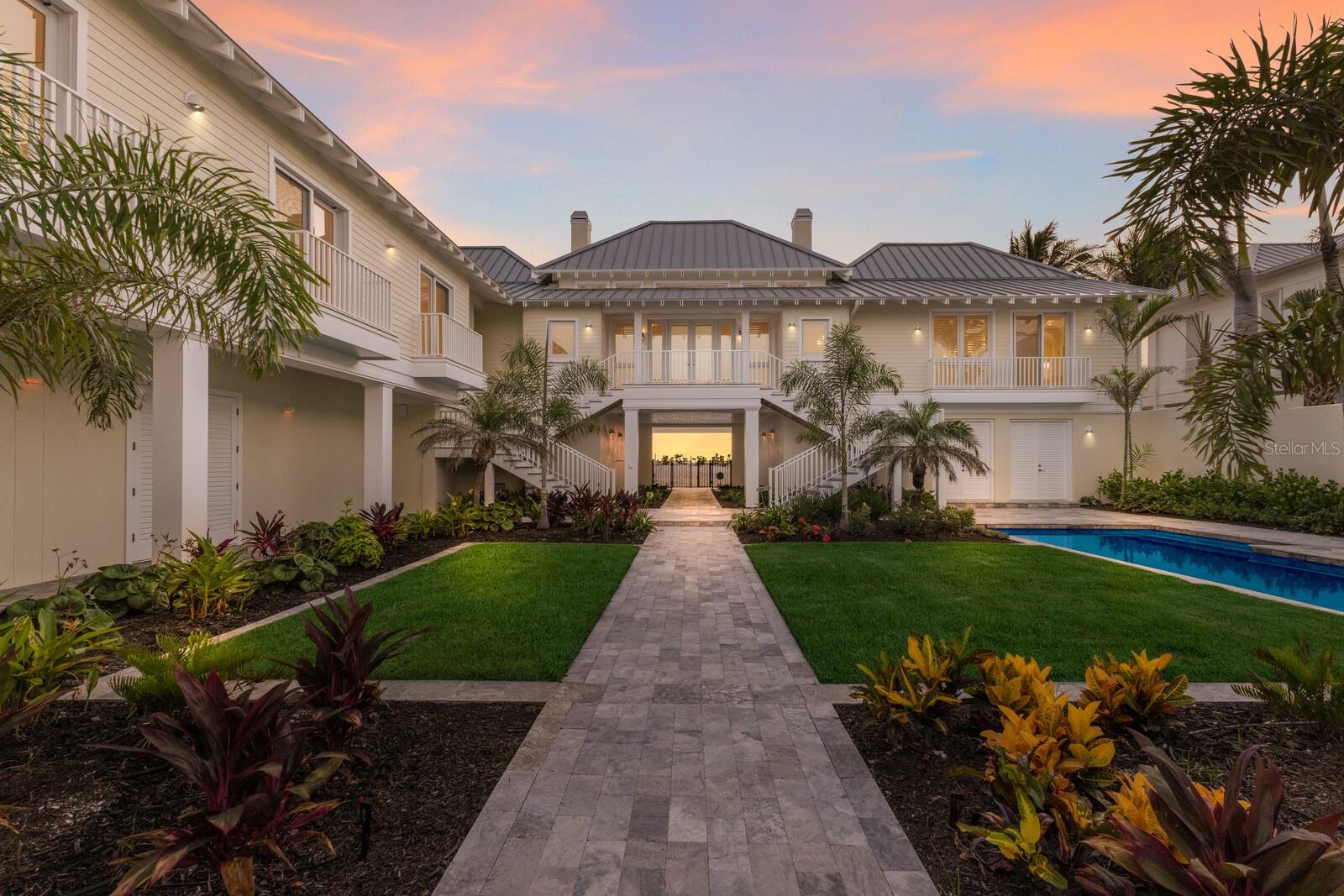 Truly a one-of-a-kind location rarely presented on exclusive Shore Lane will now be offered for purchase! Located just one estate off the Historic District and the closest in proximity to the downtown Village of Boca Grande, this prominent beachfront treasure will surely take your breath away. Built in 2016 with the owner’s vison for entertaining family and guests while creating a secluded tropical oasis unique to anything else on Gasparilla Island. This influenced Caribbean architectural gem encompasses a majestic courtyard offering the ultimate blend of solitude and spa like atmosphere. The 5-star resort style split plan lives exceptionally featuring a VIP beachside ensuite with three additional ensuite guest quarters connected by a charming covered breezeway lined with Bahama shutters and Brazilian Ipe wood hallways. Designed specifically to capture the azure seascape and green flash sunsets from nearly every room, this luxurious interior layout features an exquisite common living area with wood cladded vaulted ceilings, massive fixed-glass impact windows and doors, and a stunning dual faced coral stone handmade fireplace that commands your attention. The chef’s kitchen exudes elegance and is complimented by white oak wood cabinetry, a chic mosaic tiled mural backsplash, and a marble prep galley with cooking island & breakfast bar all being serviced by Wolf and Sub-Zero appliances. Enjoy the comfortable family and dining room concept with convenient access to the enclosed lanai operated with electric screens or relax on the open veranda with a cocktail secured by reinforced modern glass railings. The VIP master Gulfside wing features an integrated media room accompanied by a lovely terrace overlooking the courtyard pool in addition to a private covered sea watch lanai awarding the best views imaginable. Escape to the lush VIP bath enclave offering custom double wood and marble vanities, a beautiful free standing tub, and the showcase walk in marble laid shower with rain head controls. The guest wing quarters are just as impressive highlighted by a discrete office, and a unique bonus room that could serve as the 5th bedroom if needed. All the guest ensuites are complimented with white oak wood flooring, subway tiled showers, stone countertops, and each having its own personal Juliet balcony positioned prominently over the courtyard garden. Exterior storage is fantastic with over 4,000 square feet of space on lower level for all the beach toys and fishing equipment, and not to mention the additional 2 car detached twin bay garages for vehicles with convenient access to elevator. Whether spending the day basking in the sun next to the lap pool in your private courtyard or taking a swim in the warm cerulean waters of the Gulf of Mexico, this once in a lifetime setting will create a legacy retreat for family & guests that will be enjoyed for many generations to come.