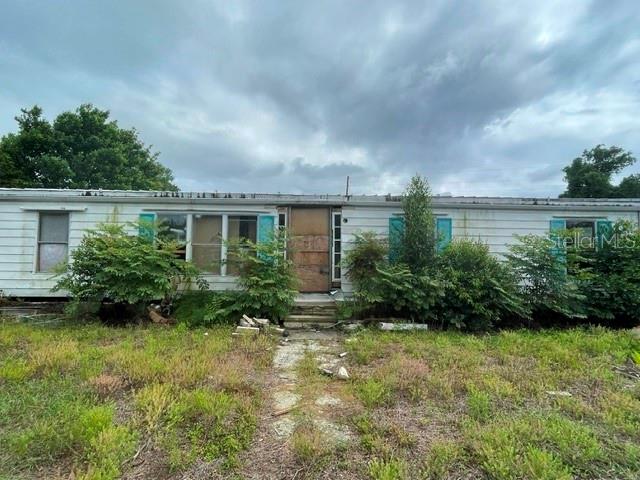 INVESTOR SPECIAL – FIXER WITH MASSIVE POTENTIAL! Opportunity knocks on this oversized .38-acre corner lot with POOL, featuring three separate structures and endless possibilities! Whether you’re an investor, flipper, contractor, or someone looking for a property with space to create your vision, this one deserves a look. The manufactured home offers an expansive layout with 3 bedrooms, 2 bathrooms, and formal dining area, but it is currently down to the studs and will require a full rehab. Bring your imagination and either replace or transform this property into something special. A standout feature is the detached storage building with attached garage located southwest of the home, offering covered parking space for multiple vehicles, workshop potential, storage, or hobby space. There’s also an additional storage building on the east side of the property that could be restored for even more functionality. Cool off during those hot Florida days in the private pool. Situated on a large corner lot in a quiet neighborhood with paved road access on two sides and NO HOA, this property offers flexibility that’s hard to find. Possible home business opportunity, room for toys, equipment, boats, trailers, or future improvements. The possibilities truly are endless! Property is being cleaned up by the owner, and is sold AS-IS with no repairs or warranties expressed or implied. Cash only. Don’t miss your chance to unlock the potential of this unique property that is PRICED TO SELL — schedule your showing today!
