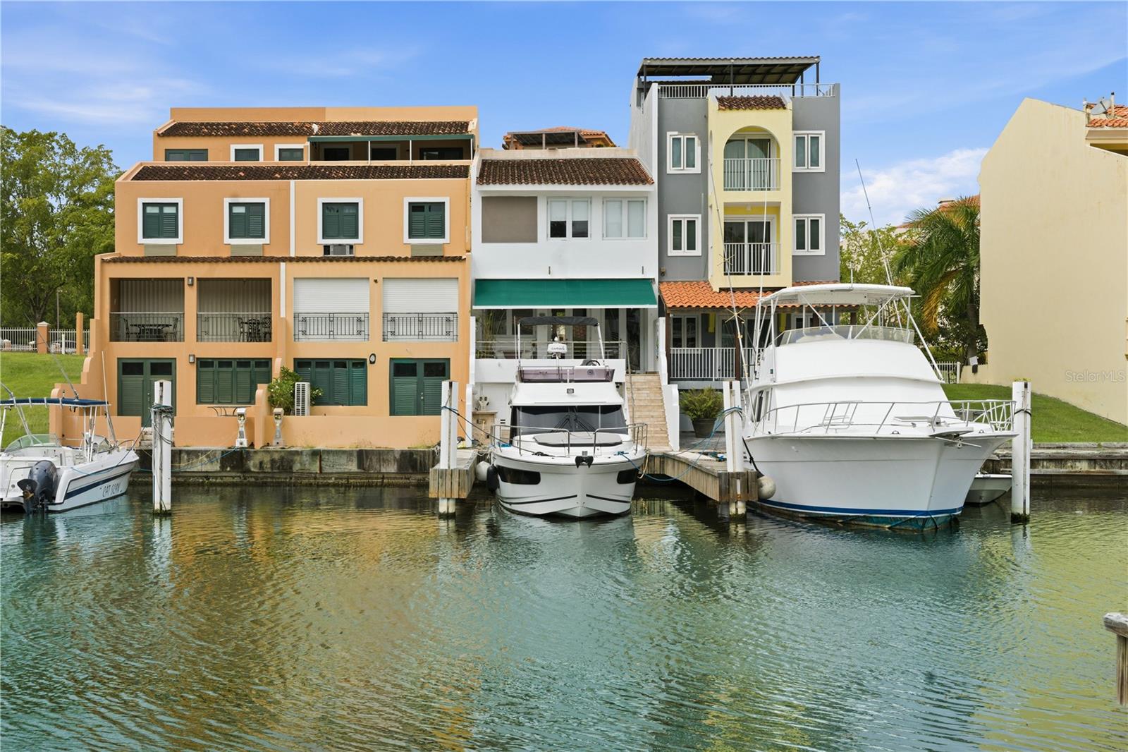 Rare marina-front turnkey home in the double-gated Plaza Mayor community of Palmas Del Mar, featuring a private deeded 50’ boat slip and newly built dock, steps from your back door.

This fully renovated 3-bedroom, 2½-bath home offers 1,615 heated sq ft with vaulted ceilings, a living room skylight, expansive windows framing the marina, brand new central and converter air conditioner units, and an electric awning on the back patio. This open-concept layout showcases luxury craftsmanship, modern coastal finishes, and a newly installed driveway, combining seamless indoor-outdoor waterfront living.

Located within a private community, enjoy walking access to 14 restaurants, beaches, golf, tennis, pickleball, gym facilities, spa amenities, and an equestrian center. A rare opportunity to own marina-front living with a deeded 50’ slip that was recently professionally dredged to create more space for marine life (tarpon, snook, snapper jacks and manatees). Certainly one of Puerto Rico’s premier resort communities — a true yacht lover’s dream.

A 35’ 2021 Jeanneau yacht with flybridge and 3 cabins is currently available for purchase ($340K) providing direct access to Vieques, Culebra, Virgin Islands, and the open Caribbean waters. This luxury yacht also provides power generation during rare outages.