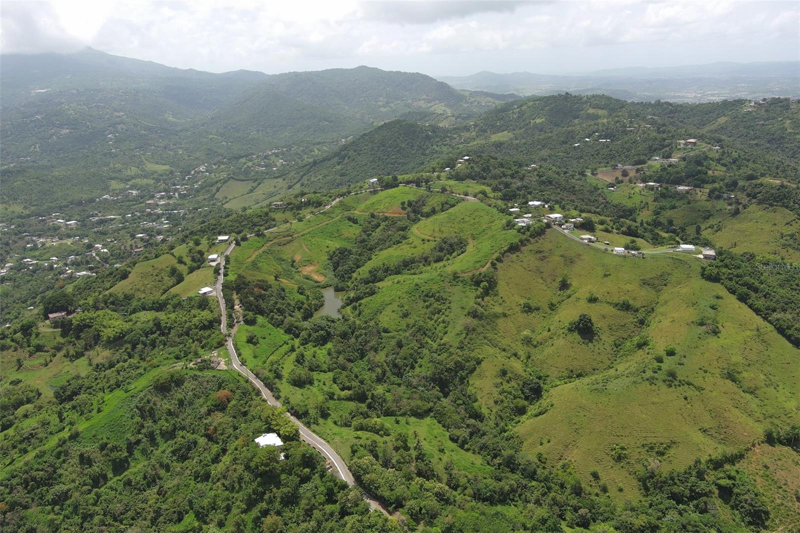 Exceptional Development Opportunity in the Hills of Carolina — 90 Cuerdas of Natural Beauty & Strategic Location

Discover a rare offering in Barrio Barrazas, Carolina — just 30 minutes from Luis Mun~oz Mari´n International Airport and within easy reach of San Juan, Trujillo Alto, Caguas, Gurabo, Juncos, and Canovanas.

This expansive 90-cuerda property combines privacy, natural resources, and stunning scenery, making it an ideal canvas for developers, investors, or those seeking a private agricultural or residential estate.

Key Highlights:

Abundant Water Supply: Multiple ojos de agua (natural freshwater springs) and a small body of water create a self-sustaining resource for agriculture, eco-living, or development infrastructure.

Panoramic Vistas: Rolling hills and elevated terrain showcase breathtaking views of both city lights and lush countryside.

Strategic Location: Close to metropolitan hubs yet tucked away in a serene setting — offering the best of countryside living with urban convenience.

Endless Potential: Whether envisioned as a luxury residential community, eco-friendly development, or private retreat, this property delivers unmatched possibilities.

Offered at $30,000 per acre (or best offer).
This is a chance to secure a prime piece of Puerto Rico’s future, where natural beauty meets visionary opportunity.