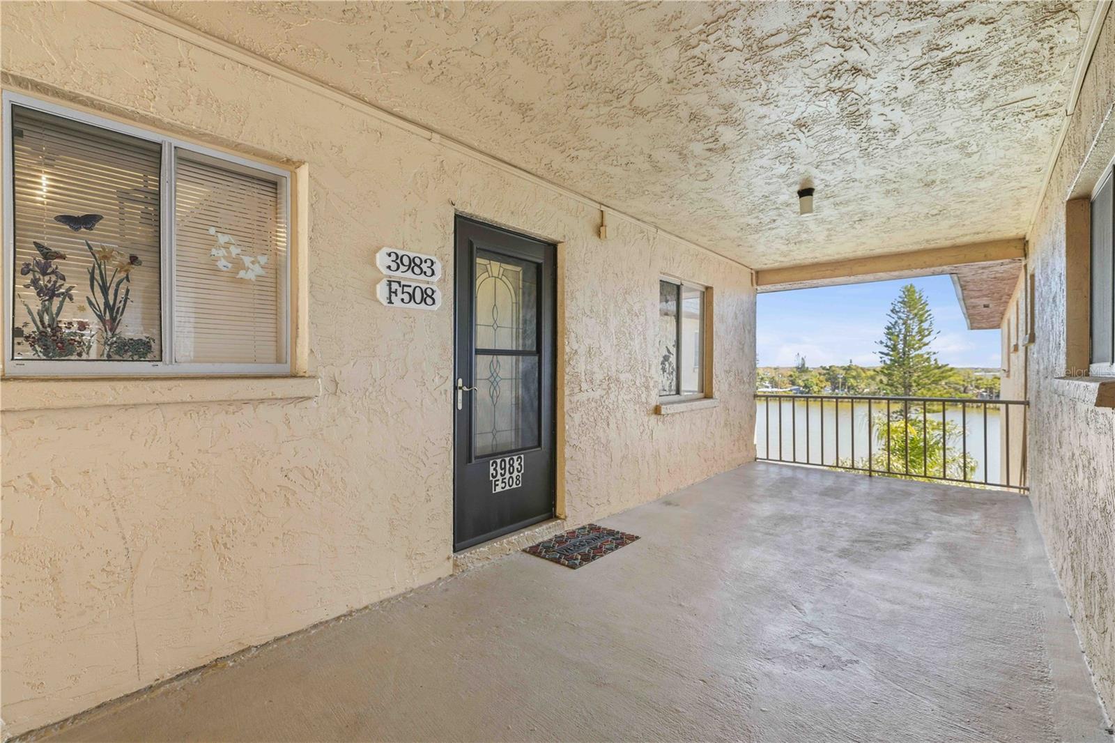 WOW...End Unit...Looking over the water, on the top floor, and NO CARPET!!  The moment you walk into this condo, your search will be over!  This one is an absolute showstopper and a true crowd-pleaser in a desirable 55+ community.  It truly checks all the boxes.  Located just steps from the elevator, with your own designated private parking spot conveniently nearby, everyday living here is effortless.  Inside, you’ll immediately appreciate the Luxury Vinyl Flooring throughout.  No overhead noise, minimal shared walls for just comfort and tranquility, only a top-floor end unit can provide.  From the 5th floor, enjoy breathtaking lake views filled with birds, turtles, and even jumping fish. As a bonus, fishing is allowed, making this view not just beautiful, but relaxing!  The living and dining areas showcase elegant architectural crown molding, adding a refined touch to the space.  The kitchen is both functional and stylish, featuring abundant solid wood cabinetry, granite countertops, and stainless steel appliances.  Perfect for everyday cooking or entertaining guests.  Both bedrooms are generously sized, with the primary suite featuring its own private en-suite bath. Throughout the condo, you’ll find stunning modern finishes that truly make a statement and leave a lasting impression.  Residents can enjoy a short walk to one of the three community pools or the clubhouse with planned activities, both of which serve as welcoming gathering spaces within the neighborhood. For those who appreciate coastal living, the property is located less than 10 miles from some of Florida’s most beautiful Gulf beaches, including Anna Maria Island. A variety of dining and shopping options are also conveniently located nearby. *BONUS includes cable and internet!  This is an extremely rare find, as this will not last long on the market.  Schedule an appointment and see for yourself!