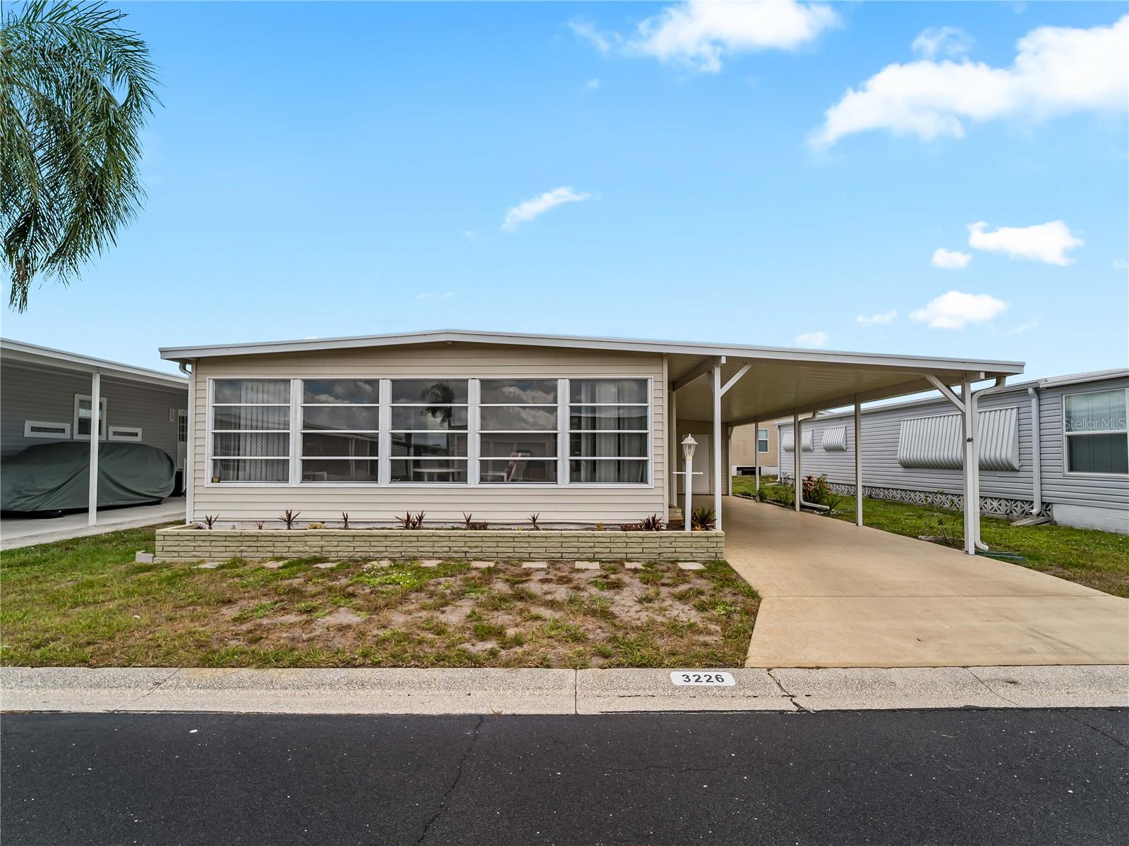 *Additional photos coming soon* Welcome to 3226 Sweet Bay Terrace in the highly desirable 55+ gated community of Oakwood Manor, the ONLY resident-owned manufactured home park within Sarasota city limits—meaning NO LOT RENT! This well-maintained 2-bedroom, 2-bathroom home offers seamless laminate flooring throughout the main living areas, kitchen, and bedrooms, creating a clean, cohesive look that's both stylish and easy to maintain. Enjoy added peace of mind with a June 2026 FULL ROOF RESTORATION, featuring a silicone roofing system over the existing metal pan roof and backed by a 10-YEAR TRANSFERABLE WARRANTY. Additional updates include a newer carport with upgraded tie-downs rated up to 150 mph (2017), HVAC (2016), and water heater (2011). Best of all, the home experienced no damage from the 2024 storms. Being offered FURNISHED, this home is truly move-in ready. Furnishings include, but are not limited to, a full-size bed in the primary bedroom, two twin beds in the guest bedroom, dining table and chairs, living room sofa, side table, TV stand with TV, chair with ottoman, some FL room/Lanai furniture, and an equipped kitchen with items needed for everyday living. The additional 8x12 shed provides for ample storage and utility space. Oakwood Manor is a beautifully maintained, gated 90-acre community offering an exceptional Florida lifestyle with a low $210/month maintenance fee, which includes lawn care, cable TV, access to the heated pool and spa, clubhouse amenities, and more. Residents enjoy a spacious clubhouse with a fitness room, library, billiards, commercial kitchen, event hall, stage, dance floor, and an active social calendar filled with year-round activities, clubs, shuffleboard, putt-putt, and community events. Ideally located adjacent to the Legacy Trail and Sarasota's city-managed pickleball courts. Oakwood Manor is located nearby downtown Sarasota and the sandy shores of Lido Beach is an easy drive, with convenient access to shopping, dining, Tamiami Trail, and I-75. Please note that Oakwood Manor is an age-restricted community and does not permit pets or motorcycles. Don't miss this opportunity to own an affordable home in one of Sarasota's most unique and sought-after resident-owned communities!