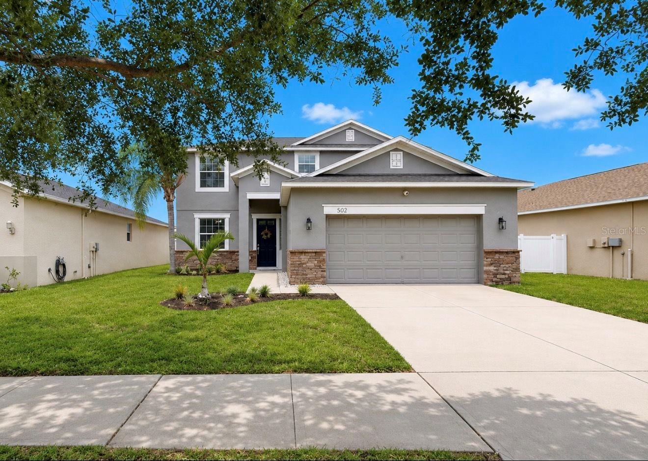 Welcome to this beautiful 5 Bed/3 Bath pond view home located in the sought after community of River Bend. With over 2300sqft under air, the desirable floorplan is open and inviting with TONS of natural light and space throughout! Exterior updates include: Newer ROOF (2022), Newer HVAC (2022), recently painted exterior (2022), and a fully fenced yard. Once inside, you are greeted with a foyer that flows seamlessly into the family room, open kitchen with dining area, and a perfect view of the outdoors! The kitchen includes updated white shaker cabinets, pendant lighting, granite countertops, and stainless steel appliances. The open flow of the space makes it ideal for entertaining and gatherings. On the first floor, there is a bedroom (currently used as an office), along with a full bathroom - perfect for guests! The sliding glass doors open to the screened lanai and back yard that boasts plants and fruit trees, along with a view of the pond. This is an ideal location for gardening and to catch amazing sunsets! Upstairs, the Owners Suite is a great place to unwind and includes a large walk in-closet and en-suite bathroom complete with relaxing garden tub, walk-in shower and double sink vanity with granite countertops. The secondary bedrooms and bath are spacious. This home truly has an amazing layout that offers plenty of space for everyone! It is move in ready with the opportunity to still add your personal touch. Located in a NON Flood Zone in the desirable community of River Bend, there are amazing amenities which include a Clubhouse, Fitness Center, New Resort Style Pool, Splash Pad, Tennis/Pickleball Courts, Basketball Court, Dog Park, Walking Trails, Fishing Docks, and year-round Community Events. Conveniently located close to major highways, shopping, and restaurants - and an easy drive to MacDill AFB and gorgeous gulf beaches! The BEST of Florida living!