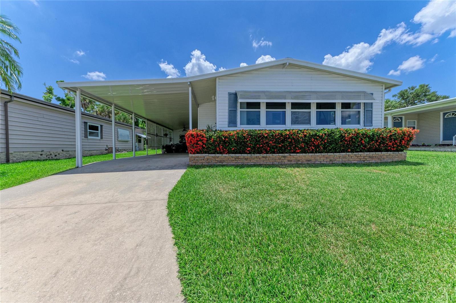 Welcome to Tidevue Estates, one of Ellenton's most desirable 55+ communities, where affordable Florida living meets convenience, privacy, and an active lifestyle. Ideally located just minutes from I-75, this charming home offers quick access to shopping, dining, healthcare, and everyday conveniences including Publix, Walmart, Costco, Detwiler's Farm Market, and more.

Tucked away near the back of the community, this well-maintained two-bedroom, two-bath residence enjoys one of the most private settings in the neighborhood. The backyard overlooks a peaceful wooded preserve, tranquil lake, and natural bird sanctuary—offering no rear neighbors, just beautiful Florida wildlife and serene views.

Inside, the bright open floor plan creates an inviting space for entertaining and everyday living. The kitchen flows seamlessly into the dining area, living room, and versatile Florida room, providing plenty of natural light and flexible living space. An additional bonus room with private exterior access from the carport offers endless possibilities as a home office, hobby room, fitness area, workshop, art studio, reading room, or peaceful retreat.

The spacious primary suite features tranquil backyard views, a large walk-in closet, and an ensuite bath with walk-in shower and private water closet. The generous guest bedroom also includes an oversized walk-in closet and is conveniently located next to the second full bathroom.

Additional features include an in-home washer and dryer, abundant storage throughout, an exterior water heater for added peace of mind, and most furnishings are included, making this home truly move-in ready. As an added bonus, the golf cart is included with the sale.

Step outside and enjoy your own private backyard oasis, perfect for gardening, birdwatching, relaxing with your morning coffee, or simply enjoying the peaceful surroundings.

Residents of Tidevue Estates enjoy an impressive selection of amenities including a heated community pool, fitness center, clubhouse, library, shuffleboard courts, walking trails, parks, and a full calendar of social activities and community events. Public transportation is conveniently located just outside the community, and you'll be only a short drive from Bradenton, Sarasota, Lakewood Ranch, Tampa, Coquina Beach, and the world-famous beaches of Anna Maria Island.

With low HOA dues of just $600 per year, exceptional community amenities, included furnishings, and a golf cart, this home offers incredible value and the Florida lifestyle you've been searching for.

Schedule your private showing today and discover why Tidevue Estates is one of Manatee County's hidden gems.