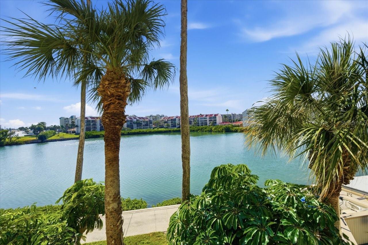 Absolutely gorgeous Condo with absolutely gorgeous views and amenities!  Welcome to Bay Island--one of Florida's Gulf Coast's most coveted gated communities!  Fabulous for a weekend getaway or a sunshiny retreat. Every day at Bay Island feels like a vacation! Come see this beautiful coastal redesigned condo that you will be proud to call yours. Corner unit with private balcony & west facing sunset views- 2 bedrooms + den, 1,300 sq ft, and a light-filled layout that has been thoughtfully reimagined down to the studs. Facing west, this condo enjoys breathtaking water views from every window. Watch the sky turn pink and gold each evening as the sun sets over the Intracoastal, framed perfectly from your living room, kitchen, bedrooms, and balcony. WASHER/DRYER will be added in DEN CLOSET area prior to Closing if Buyer desires it in the unit.

The interior has been completely redesigned and remodeled with a modern coastal aesthetic—new drywall, doors, trim, flooring, lighting, updated kitchen and baths, new A/C system. & ductwork and inside washer/dryer for your convenience. This unique floorplan lives more like a home than a traditional "rectangle box" condo. And the versatile den offers the ideal flexible space for guests or an office, yoga studio, or craft room. The kitchen overlooks the dining and living area, so you won't mind cooking at all! Plenty of cabinetry and closet space as well as additional storage unit.  And right outside of your building's front door- the waterfront heated pool and spa feel like your own backyard—just steps away for effortless enjoyment.

Bay Island is known for its resort-style lifestyle, and it is one of only a few communities that are gated and manned with 24hr guard gate.  For residents and their guests to enjoy- there are 6 heated pools, 2 jacuzzi, saunas, tennis and pickleball, shuffleboard, full fitness center, billiards, library, clubhouse, Tiki BBQ areas, marina access, and a stunning 1.5-mile waterfront walking path where it’s common to see dolphins play, manatees glide by, and a variety of coastal birds soaring overhead. The Ambassador building has also completed its milestone/structural inspections for added peace of mind. There are bike racks for your convenience, and the nearby SunRunner Line offers quick and easy Gulf of Mexico beaches access as well as Downtown St Pete without ever getting in your car!

All of this in a location that is second to none—just minutes to St. Pete Beach, Treasure Island and Sunset Beach, Corey Avenue’s shops and cafés and Sunday morning market, close to kitschy cute  Gulfport, and only 15 minute drive to all of the exclusive dining, arts, waterfront parks, museums, and energy of Downtown St. Petersburg. Close to Banks and Palms of Pasadena medical facilities and 20 mins to Tampa International Airport.  
Come see this beautiful condo and live the active and beautiful Florida Life!