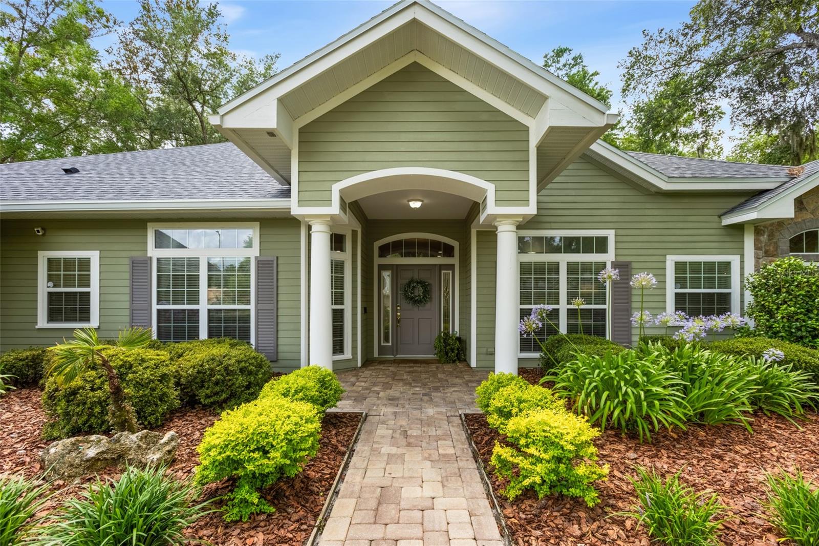 Welcome to this stunning 3-bedroom, 2.5-bath home with a dedicated study, built by renowned Arthur Rutenberg Homes and located in the highly sought-after Wilds Plantation community of Southwest Gainesville. Situated on a prime corner lot, this beautifully maintained residence features an open-concept floor plan, soaring ceilings, spacious living areas, and a fully fenced backyard surrounded by mature landscaping and majestic oak trees.

Upon entering, you're greeted by an inviting foyer that opens to an expansive great room featuring custom built-ins, a gas fireplace, and surround sound with receiver included—perfect for both everyday living and entertaining. The formal dining room is elegantly positioned at the front of the home, creating a welcoming space for hosting family and guests.

The well-appointed kitchen offers solid-surface countertops, crisp white cabinetry, a huge walk-in pantry, and a casual dining area enhanced by additional cabinetry and counter space—ideal for a serving station, coffee bar, or entertaining setup.

Privately tucked away, the spacious owner's suite offers peaceful backyard views, room for a sitting area, two walk-in closets, and a luxurious bath featuring a double vanity, soaking tub, and separate shower. A separate guest wing provides privacy for family or visitors and includes generously sized bedrooms with large, lighted closets.

Step outside to the oversized screened lanai and enjoy the tranquil backyard oasis, perfect for relaxing or entertaining year-round. Additional highlights include abundant storage throughout, upgraded LED lighting, a side-entry two-car garage with an additional golf cart bay, and a security system with five exterior cameras.

Ideally located off SW 24th Avenue, Wilds Plantation offers convenient access to the University of Florida, UF Health, North Florida Regional Medical Center, top-rated schools, shopping, dining, and more.

Recent updates include a new roof installed in January 2026  and new stainless steel kitchen appliances, including a wall-mounted microwave and oven combination. Top rated schools: Chiles Elementary, Kanapaha Middle and Buchholz High.