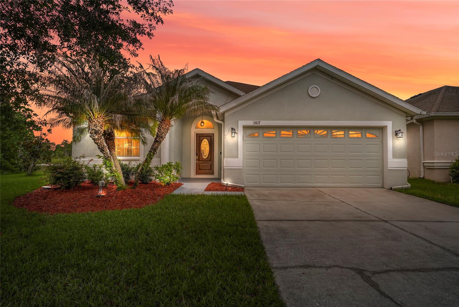 Welcome to an exclusive private residence in the highly coveted Meadow Pointe community, ideally located in the heart of Wesley Chapel. Perfectly positioned at the end of a quiet cul-de-sac, this exceptional home is surrounded by sprawling green space, natural beauty, and private water views, with no neighbors to the east. The setting offers a rare sense of privacy and tranquility, creating a true sanctuary designed for refined everyday living.
From the moment you enter, the home makes a sophisticated statement with exquisite porcelain flooring flowing seamlessly through the open-concept living spaces. The expansive layout is designed for both elegant entertaining and relaxed evenings at home, centered around a custom stone-framed fireplace and media wall that adds warmth, character, and architectural distinction.
The chef-inspired kitchen blends luxury and functionality with brushed stainless steel Whirlpool appliances, granite countertops, solid wood custom cabinetry, and an artistic backsplash. Designed to inspire restaurant-quality meals from the comfort of home, this custom kitchen flows beautifully into the living and formal dining room, creating an impressive setting for intimate dinners, holiday gatherings, and unforgettable entertaining.
The living space extends effortlessly to the oversized screened patio, where a custom outdoor kitchen with granite countertops, a wine fridge, and BBQ area elevates Florida outdoor living. Surrounded by lush greenery, breathtaking privacy, tranquil pond views, and awe-inspiring private sunrises, this outdoor retreat offers the perfect backdrop for morning coffee, evening relaxation, or entertaining under the glow of the Sunshine State.
The primary suite offers a peaceful escape, complete with a relaxing four-piece ensuite designed for comfort and privacy. Two inviting guest bedrooms provide welcoming accommodations for family or overnight guests, while the beautifully appointed guest bath features a custom LED mirror and three-piece design. A private office adds flexible space for business, study, or creative inspiration.
Every detail of the home reflects thoughtful customization and elevated design, including smart LED lighting with app-controlled switches, custom bullnose wall finishes throughout, rich custom wood flooring in the bedrooms, and motorized custom drapery for effortless movement. No detail was overlooked in creating a home that feels polished, private, and distinctly luxurious. Tour this lovely home before it's gone!