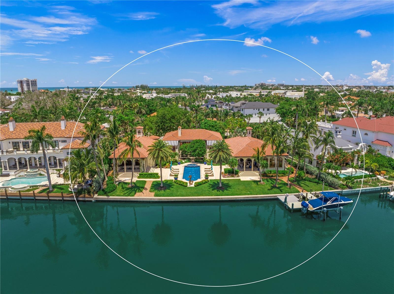 Timeless Elegance, Effortless Living where HISTORY Meets MODERN LUXURY @ "Casa del Carnevale," an exquisite waterfront estate, situated in the prestigious St. Armands Key, the neighborhood of John Ringling Estates. This home seamlessly blends history with modern luxury, offering views of the Sarasota Waterway and Bay with a historic designation. Casa del Carnevale presents a rare opportunity to own an esteemed historical property. Offered for only the fifth time in its storied history, this exceptional estate combines Old World architectural charm with contemporary opulence. The home underwent an extensive renovation, with meticulous attention to detail and craftsmanship, utilizing top-tier materials and artisanship. Expanded from 4,000 to nearly 10,000 sq. ft. under roof, and featuring over 7,800 sq. f.t of air-conditioned space, Casa del Carnevale preserves its original charm while offering a reimagined layout that exceeds modern luxury standards.  Set on three sprawling lots, 30,000+ square feet, the estate boasts 171 feet of waterfrontage, a private dock lift, a floating lift for jet skis and kayaks, and breathtaking views of Sarasota Waterway. The lush, meticulously designed tropical landscaping creates a private oasis that feels like you are walking in Selby Gardens on St. Armands. The residence includes five bedrooms and six and a half baths across two spacious levels with an elevator. Multiple terraces provide perfect outdoor retreats and entertaining areas, all complemented by stunning garden water vistas, a central courtyard, and an elegant 65' saltwater pool and spa with arched spraying fountains and iridescent glass tiles. Other luxury features include a three-car garage, elevator, nanny’s quarters, walk-in wine room, billiards room, office, and custom impact-glass arched windows designed to maximize unobstructed views. The chef’s kitchen boasts premium finishes, top-of-the-line appliances, a 5-Star La Cornue range and hood from France, featuring gas or electric ovens (kitchen art). Sub-Zero refrigerators, a Bosch dishwasher, a Miele microwave, a Miele built-in coffee machine, a stand-alone beverage refrigerator, and a stand-alone ice maker.  Throughout the home, exposed beams, warm wood tones, natural stone, custom ironwork, Pecky Cypress wood throughout, and curated artwork create an inviting, sophisticated atmosphere. Offering furniture (negotiable under separate contract), and instant enjoyment to create everlasting memories, Casa del Carnevale is a rare and exquisite blend of history, elegance, and modern comfort on one of Sarasota’s most coveted waterfront estates. EASY TO SHOW.  CASA DEL CARNEVALE IS A MUST-SEE IN PERSON TO FULLY APPRECIATE.