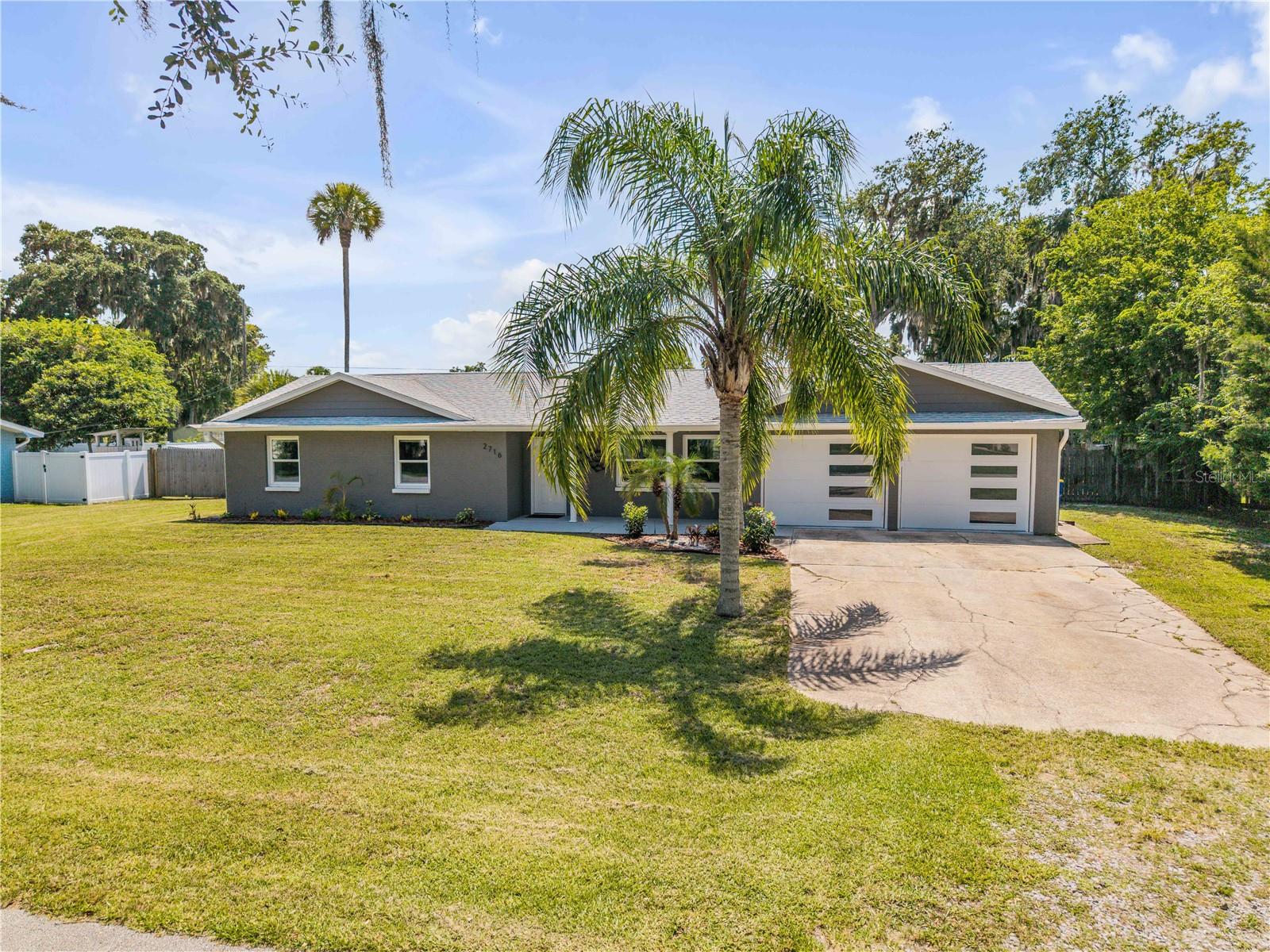 Move-In Ready, Fully Remodeled, No HOA, and a Rare Triple Lot in Edgewater!

If you've been searching for a move-in ready home in Edgewater with room for all your toys, modern updates, and no HOA, welcome to 2716 Kumquat Drive. Situated on a rare oversized fenced triple lot, this beautifully remodeled property offers the space, flexibility, and lifestyle Florida buyers are looking for.

Enjoy peace of mind knowing the home's major systems have already been updated, including a new roof, HVAC system, and all-new appliances in 2023. From the moment you arrive, you'll appreciate the tropical landscaping, irrigation system, covered front entry, and inviting curb appeal.

Inside, you'll find a bright, modern interior featuring luxury vinyl plank flooring, updated baseboards, stylish lighting, ceiling fans, and a beautifully remodeled kitchen complete with new cabinetry, granite countertops, and contemporary finishes. Both bathrooms have been tastefully renovated with updated vanities, tiled tub surrounds, and modern fixtures, creating a true turnkey home ready for its next owner.

The oversized garage is a dream for hobbyists, car enthusiasts, or anyone needing extra space. Featuring two bay doors with new openers, freshly finished floors, and two enclosed bonus rooms, it offers endless possibilities for a workshop, home gym, storage, office, or creative space.

Step outside and discover one of this property's biggest advantages—a fenced triple lot with endless possibilities. There's room for a pool, detached garage, workshop, garden, playground, or plenty of space to park your boat, RV, trailer, or recreational vehicles. With no HOA restrictions, you have the freedom to truly make this property your own.

Located in the heart of Edgewater, Florida, you'll enjoy a laid-back coastal lifestyle just minutes from the Intracoastal Waterway, public boat ramps, parks, shopping, dining, and the white-sand beaches of New Smyrna Beach. With easy access to I-95, commuting throughout Central Florida is simple while still enjoying the charm of a waterfront community.

Whether you're looking for a primary residence, retirement home, or investment opportunity, this updated Edgewater home offers the space, upgrades, and Florida lifestyle buyers have been waiting for.