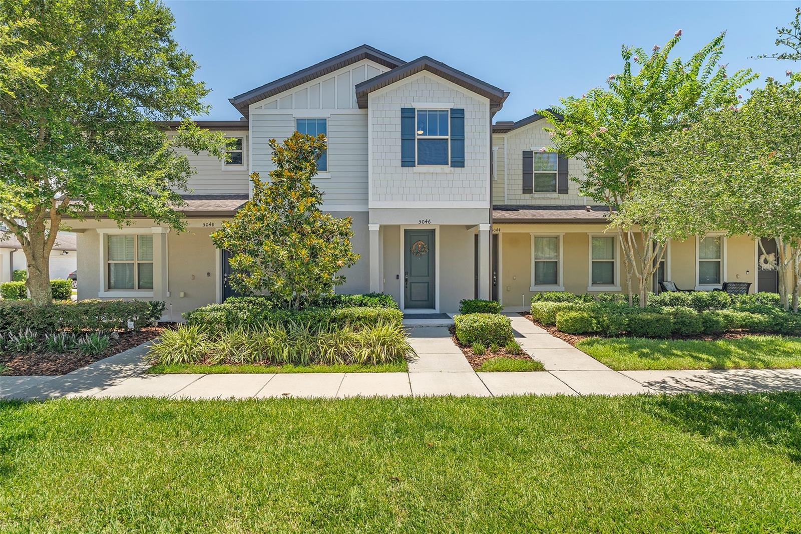 Move right into this beautiful 4 bedroom, 3 bathroom townhome located in a sought after Lakeshore at Narcoosee gated community! Designed with an open and inviting floor plan, this home features brand-new carpet and tile throughout, creating a fresh, modern feel. The spacious kitchen is perfect for entertaining, offering granite countertops, a stylish tile backsplash, stainless steel appliances, and a breakfast bar overlooking the living and dining areas. The owner's suite is a private retreat with a large walk-in closet and an en-suite bathroom featuring dual granite vanities and an oversized tiled shower. Additional interior features include a central vacuum system, motorized blackout shades, a convenient under-stair storage closet, and a laundry room complete with washer and dryer. Step outside to enjoy the private paver patio, ideal for relaxing or entertaining, with a detached 2-car garage which is also a workout area with TV and mirror connected by a charming breezeway. Residents enjoy an exceptional lifestyle with resort-style amenities, including a clubhouse, swimming pools, state-of-the-art fitness center, playground, dog park, lighted tennis courts, and a scenic community dock with access to Fells Cove and East Lake Tohopekaliga. Conveniently located just minutes from Lake Nona Medical City, Orlando International Airport, shopping, dining, and major roadways, this home truly offers the perfect blend of comfort, convenience, and Florida living. Don't miss your opportunity to make this exceptional home yours!