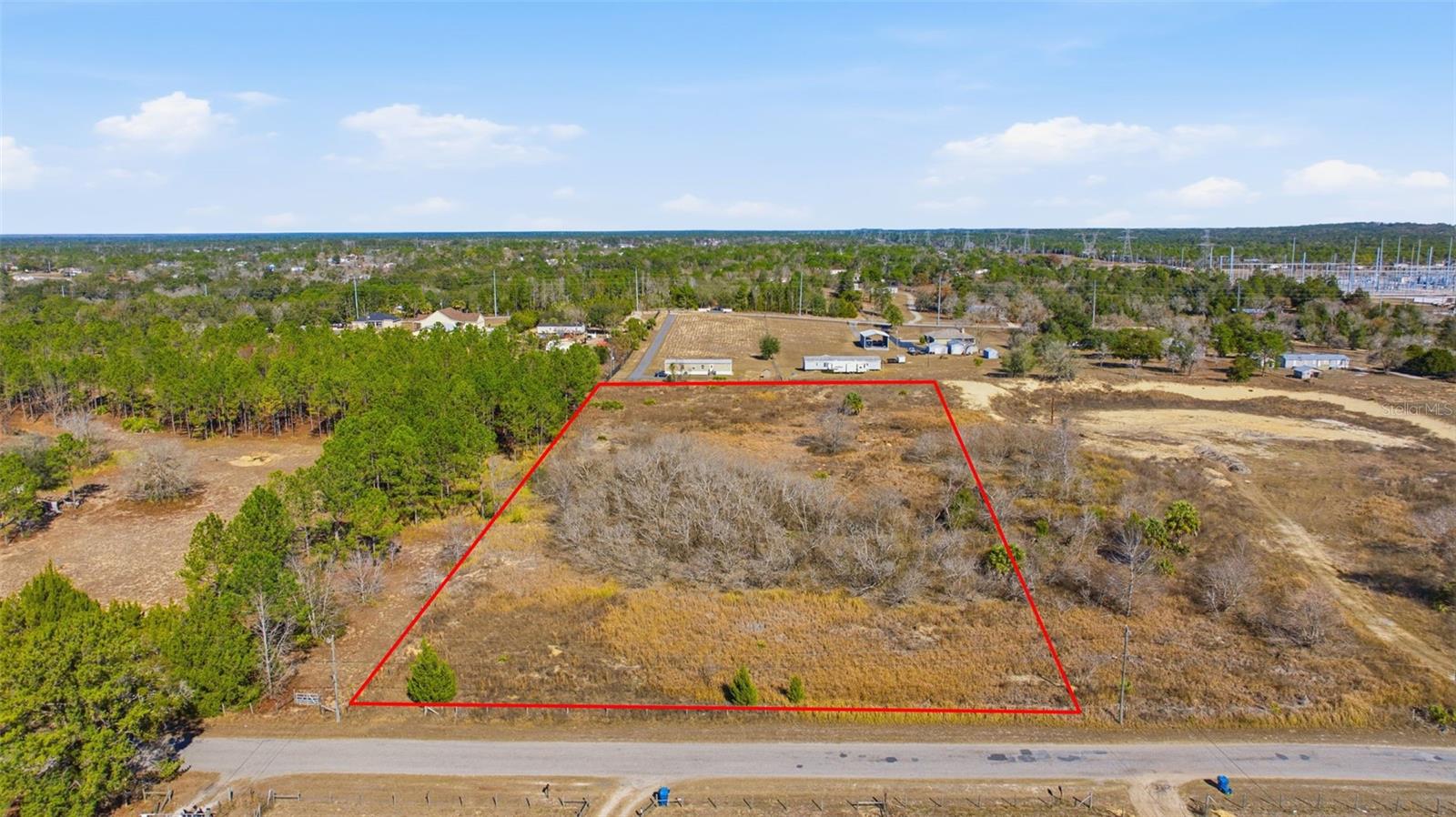 Discover almost 5 acres of beautiful vacant land with paved road frontage, offering the perfect blend of peaceful country living and everyday convenience. Located just minutes from shopping and dinning this property provides a rare opportunity to enjoy privacy without sacrificing accessibility. With plenty of room for a custom home, animals or a garden the possibilities are endless. Surrounded by natural beauty and open space, this serene parcel is ideal for creating your own private retreat in a highly desirable area.