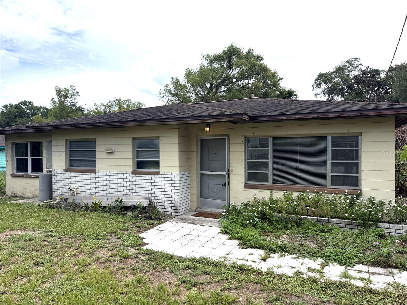Affordable acreage feel in Lutz with updated kitchen and bath, huge screened porch, fenced yard, and endless potential. Whether you’re looking to renovate, invest, or create your own private retreat, this property offers space, character, and opportunity that’s getting harder to find. Opportunity awaits on this fenced oversized lot in the heart of Lutz! This 2 bedroom, 1 bathroom home offers 1,088 sq. ft. of living space PLUS an expansive 12’ x 29’ screened porch perfect for relaxing, entertaining, hobbies, or additional outdoor living enjoyment.

Inside, you’ll find a blend of updates, character, and renovation potential. The kitchen features newer white shaker cabinetry, butcher block countertops, and a stylish glass accent backsplash. The bathroom has been updated with classic hexagon tile surround and modern finishes. The dining room showcases ceramic tile laid on a 45-degree pattern along with a custom plaster ceiling medallion that adds a unique architectural touch.

The large living room offers excellent flexibility with a substantial closet area and potential for conversion into additional sleeping or office space. Spacious bedrooms, abundant natural light, and multiple gathering areas provide a comfortable layout with room to personalize over time.

Step outside and enjoy the privacy and possibilities of this over 1/3-acre fenced property. The oversized screened porch overlooks a backyard filled with mature trees and open space ready for gardening, recreation, storage, or future improvements.

Conveniently located near shopping, restaurants, major roadways, and everything Lutz and North Tampa have to offer, this property presents a great opportunity for investors, renovators, or buyers looking to create value and make a home their own.

Bring your vision and unlock the potential of this charming Lutz property!  Upgraded 200 amp panel in 2022, AC is 2017, Septic Drain field with lift station installed 2024, roof in 2011.