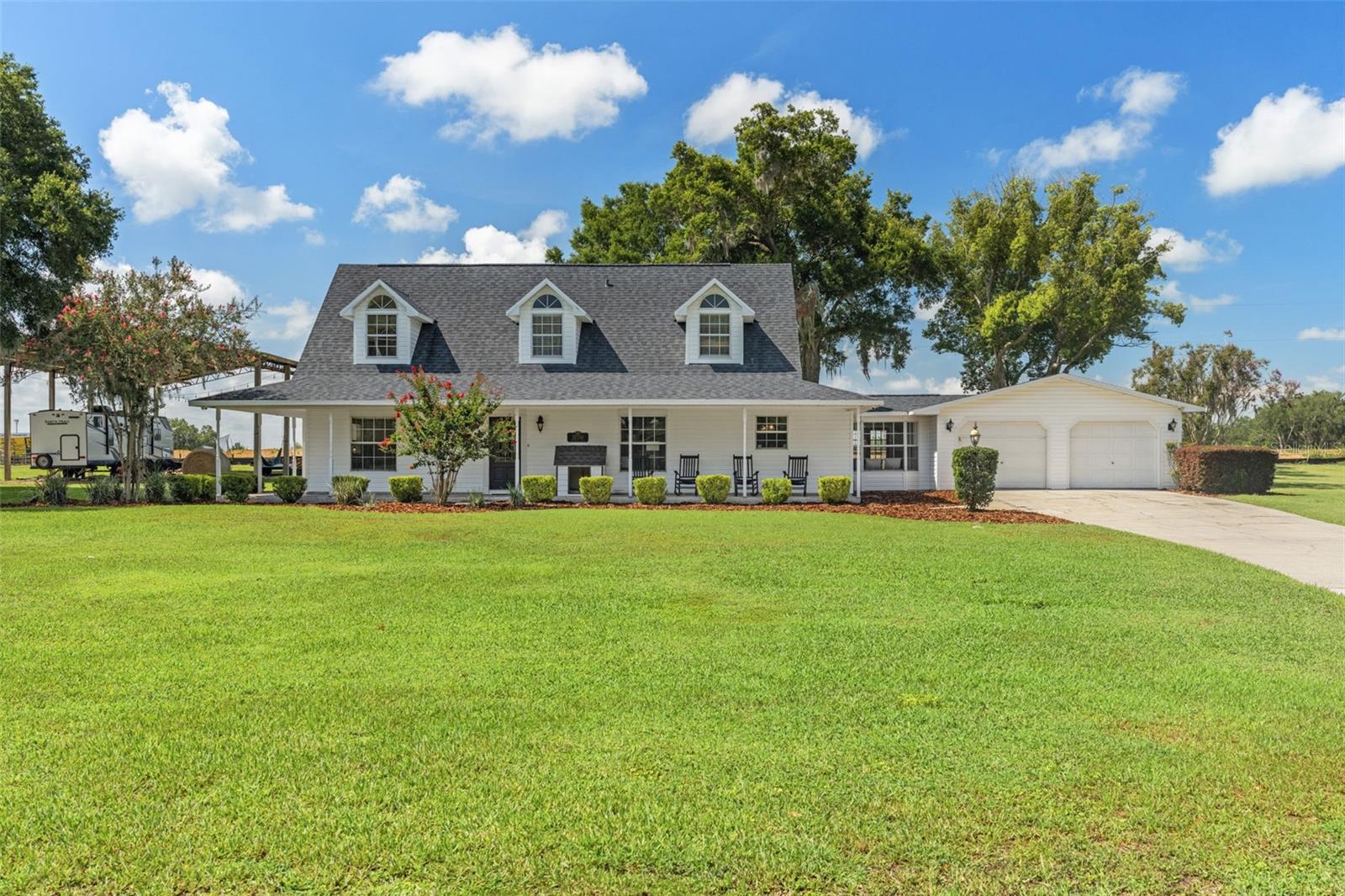 Incredible opportunity to own an amazing property in a highly desirable neighborhood near Downtown Dade City! Sitting on OVER AN ACRE on a dead end street, just minutes from Downtown, this beautiful 3 bedroom + 2 flex room + 2.5 bathroom + 2 car garage + pole barn + POOL home has it all! Non-flood zone and no HOA! This property features a 40x60 foot steel pole barn with a 200amp electrical box, a full RV hookup with 30amp electric and water supply. This is perfect for RV and boat storage, livestock housing, or an easy conversion to a guest house! A large front porch, beautiful landscaping, and privacy hedges welcome you up to this beautiful home. Upon entry, the living room featuring soaring ceilings and a functional wood burning fireplace are welcoming and cozy. The farmhouse style kitchen includes a custom built island with wine racks and seating, a cooktop, built in oven, stainless steel appliances, and a pantry. The primary bedroom is conveniently located downstairs and features beautiful wood flooring, a walk-in closet with custom shelving, an en suite bathroom with double vanities, and a soaking tub, and a stand up shower. Upstairs features 2 guest bedrooms and a spacious guest bathroom with double vanities. Both bedrooms have beautiful dormers, adding architectural character and tons of natural lighting. 3 full bedrooms encompass this home, with an additional spacious room that can be used as a 4th bedroom, office, or a formal dining room. There is also a sunroom right off the garage with a bay window and french doors leading to the pool, that can be used as an office, reading room, or mud room. Leading out to the pool is a half bath and a walk in laundry room for easy cleanup after pool days. Enjoy the heated saltwater pool and spa year around, surrounded by a fully pavered pool deck and fence. There is plenty of parking here with an extra long driveway and an oversized 2 car garage. Additional features of this home include: Roof 2021, one HVAC system 2026, under stair storage, shiplap throughout, and a chicken coop with a water supply. The location is just as impressive as the home itself! Golf cart, bike, or walk to charming Downtown Dade City, where you'll enjoy an abundance of locally owned restaurants, boutiques, antique shops, and specialty stores, along with vibrant community events held throughout the year, including monthly Street Bashes, farmers markets, classic car shows, and the world-famous annual Kumquat Festival each January. Just blocks away, Church Avenue comes alive during the holidays with the beloved Christmas Stroll, featuring beautifully decorated homes, caroling, and festive celebrations. During Halloween, the streets are closed to traffic, creating a safe and unforgettable trick-or-treat experience for families. Outdoor enthusiasts will love the convenient access to the scenic Hardy Trail, offering paved pathways perfect for walking, running, or biking through both shaded and open areas. As an added bonus, Fairfield homeowners enjoy private access to the Hardy Trail directly from the end of the cul-de-sac, making it easy to take advantage of everything this incredible community has to offer. This is truly an amazing home in an incredible location!