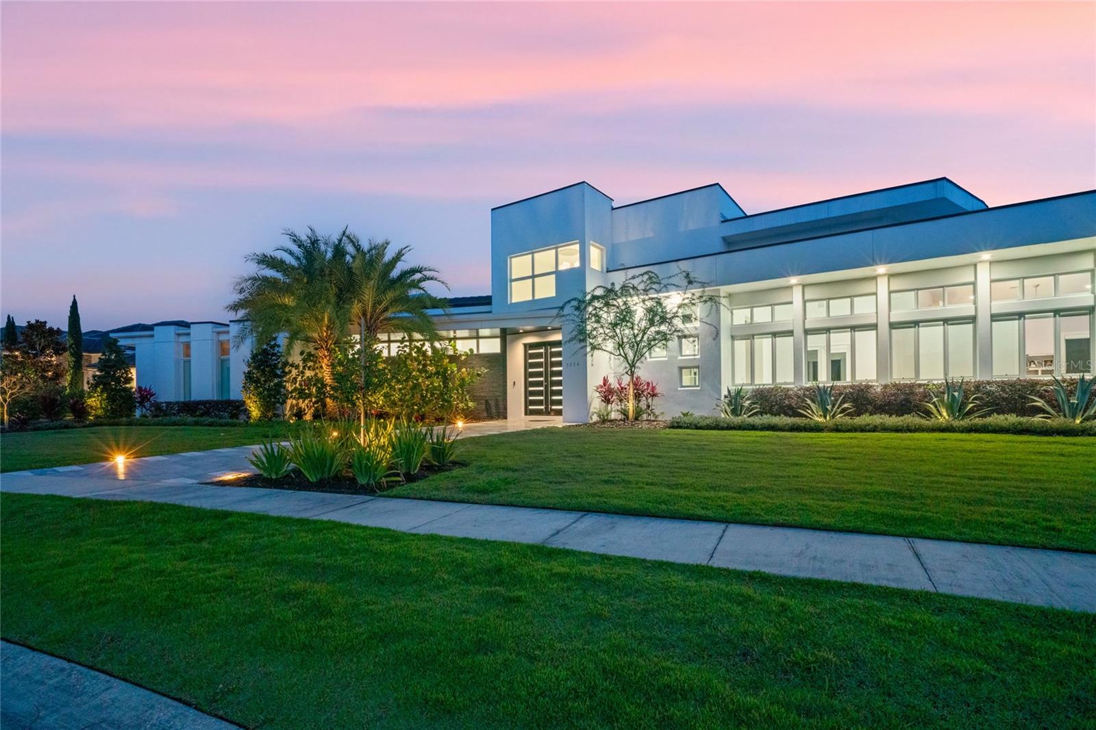 Welcome to your MODERN CUSTOM HOME in the exclusive Sawyer Sound neighborhood! This rare single-story Cam Bradford masterpiece boasts an expansive open floor plan. Designed with family and entertainment at its core, the home is bathed in natural light, thanks to stackable sliding doors that merge the indoors with a serene pool area.

For the culinary enthusiast, the CHEF'S DREAM KITCHEN awaits. Adorned with natural stone quartzite countertops, high gloss Boca Acrylic cabinets, and a Thermador PROFESSIONAL SERIES range, hood, and double oven, every meal becomes a celebration. The kitchen also features a concealed walk-in pantry and refrigerator drawers in the island, ensuring snacks and drinks are within everyone's easy reach. Start your mornings with the Brew Express built-in coffee maker, conveniently located opposite the Thermador Microdrawer.

Elevate your hosting game with the IMPRESSIVE CUSTOM BAR. Highlighted by a backlit onyx wall and underbar, it comes equipped with a built-in ice maker and double wine refrigerator.

The SPACIOUS OWNER'S SUITE is a haven of luxury, complete with two walk-in closets and an en suite bathroom showcasing a herringbone marble tile shower. Adjacent to the suite is a well-appointed home office with high gloss cabinetry. The home also offers an additional living space, perfect as a playroom or teen lounge, equipped with a dry bar and refrigerator drawers. Three more bedrooms come with ENSUITE PRIVATE BATHROOMS. Need more space? The MOTHER-IN-LAW SUITE, currently a second office, offers pool views and can easily serve as a 5th bedroom.

The air-conditioned 3-car garage houses an electrical room for the home's video surveillance system. A vast laundry room accommodates two washer-dryer sets and offers ample storage.

The outdoor area is a true showstopper. Retractable screens, a state-of-the-art outdoor kitchen, a fire-pit, and a saltwater pool with DANCING WATER JETS promise endless fun. As night falls, built-in LED lighting accentuates the home's elegance.

Nestled in a gated enclave of around 20 private estates, Sawyer Sound promises exclusivity. Located in the esteemed Windemere School district, it's a stone's throw from Disney World (6 miles) and Universal Studios (11 miles).

Experience luxury like never before in this exquisite custom home. Your journey of opulence awaits! Room Feature: Linen Closet In Bath (Primary Bedroom).