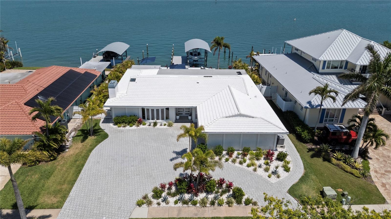 Welcome to Wow, welcome to 631 Harbor Island! This 2653-square-foot single-level waterfront residence is a masterclass in intentional design. While the original slab, exterior walls, and roof remain solidly intact, the current owner has completely transformed the interior -  essentially rebuilding the home from the inside out – every surface, system and finish has been upgraded to high-end, luxury standards with meticulous care and attention to every detail in partnership with Premier Construction of Tampa.
30X30 porcelain tiles, Subzero, Miele, Cove and Wolf appliances and spa-like bathrooms create an environment that feels brand new and meticulously curated.  The layout was designed for coastal living. Four spacious bedrooms and 3.5 spa-like bathrooms are all on one level with zero stairs. No oversized maintenance. No wasted space. Just pure, intentional luxury that delivers more effortless enjoyment—and more value—than homes twice its size.
Open-concept living spaces bathe in natural light and flow seamlessly to the outdoors, perfect for both intimate evenings and larger gatherings. Step outside and magic unfolds: A newly reimagined pool and spa with fire boxes, sundeck, outdoor shower, sauna, kitchen fit for a king to entertain to your heart’s delight with premium Sonos sound, multiple TVs to watch the Big Game, and places to sit, relax and watch the sun rise, the dolphins play and boats glide by.
The dock, covered 26K-lb boatlift, 50+-ft wet slip with wrapped pilings are all new and include water and electric. There was no skimping on the toy box of the home either (garage).  Complete with an epoxy floor and its own mini-split AC to keep cars cool and comfortable in the Florida summers. This is coastal living distilled to its most refined form—with every luxury thoughtfully placed.
If you’ve been searching for a waterfront retreat that feels fresh, personal, and truly special, this is the one. The combination of completely renovated luxury, single-level living, and that rare open Intracoastal frontage makes this property stand in a class of its own.
Don’t miss your chance to experience it in person. Request your private showing today — once you stand outside and take in those endless views, you’ll understand exactly why this home stands apart.