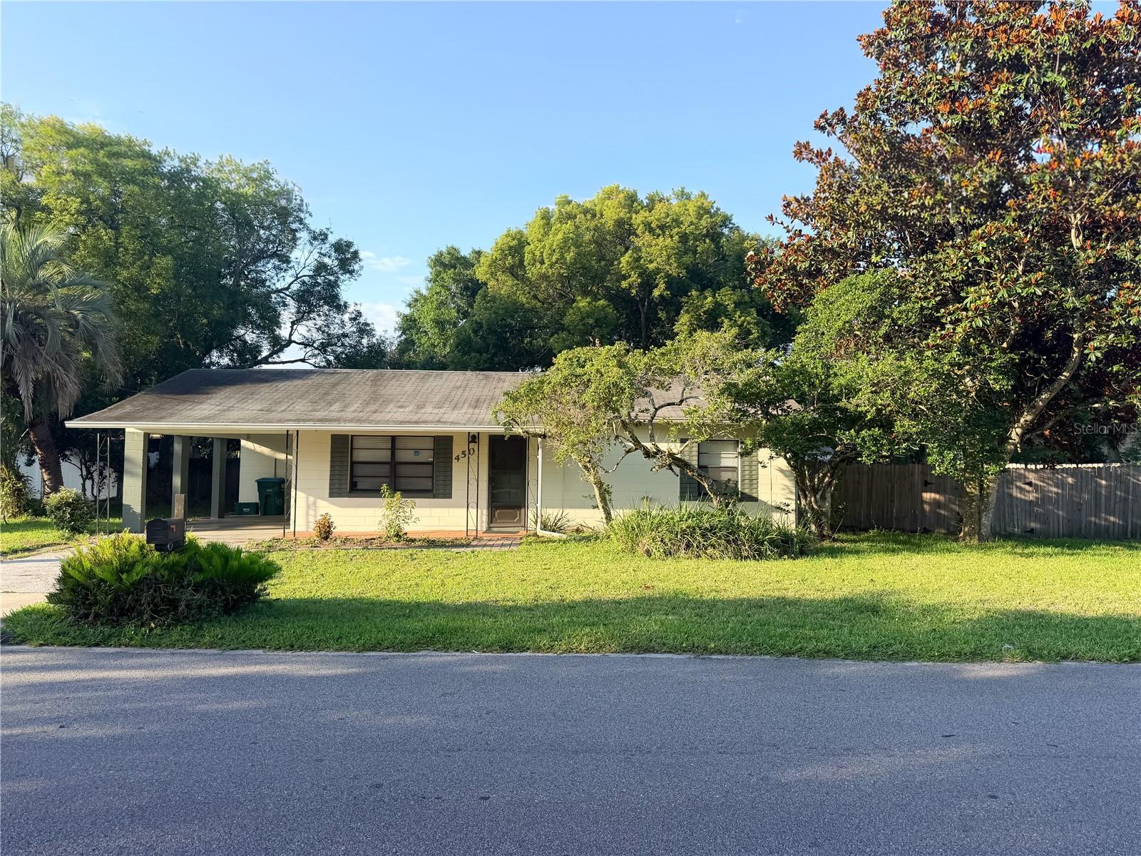 Situated on an oversized double lot in the heart of Longwood, this 2-bedroom, 1-bath home offers endless potential for homeowners and investors alike. Offering a spacious living room, a functional kitchen, and an updated bathroom with walk-in shower, the home also features tile flooring throughout the main living areas and carpet in the bedrooms, making it ready for someone to move in and make it their own. Just off the kitchen and dining area, a recently installed patio creates the perfect outdoor entertaining space, complete with corner posts ready for shade sails or a custom covered seating area. The large lot provides mature landscaping, beautiful shade trees, and ample space to park an RV, boat, or additional vehicles with no HOA restrictions. Additional features include a covered carport with separate laundry room and utility sink, an extra storage room at the rear of the home, and a detached storage shed with an attached covered storage area ideal for lawn equipment, tools, or outdoor gear. Roof replaced in 2015, water heater installed in 2022, New Washer & Dryer 2022, and connected to public sewer. Whether you're searching for your first home, a solid investment property, or a home with room to expand and make your own, this versatile property offers endless possibilities.