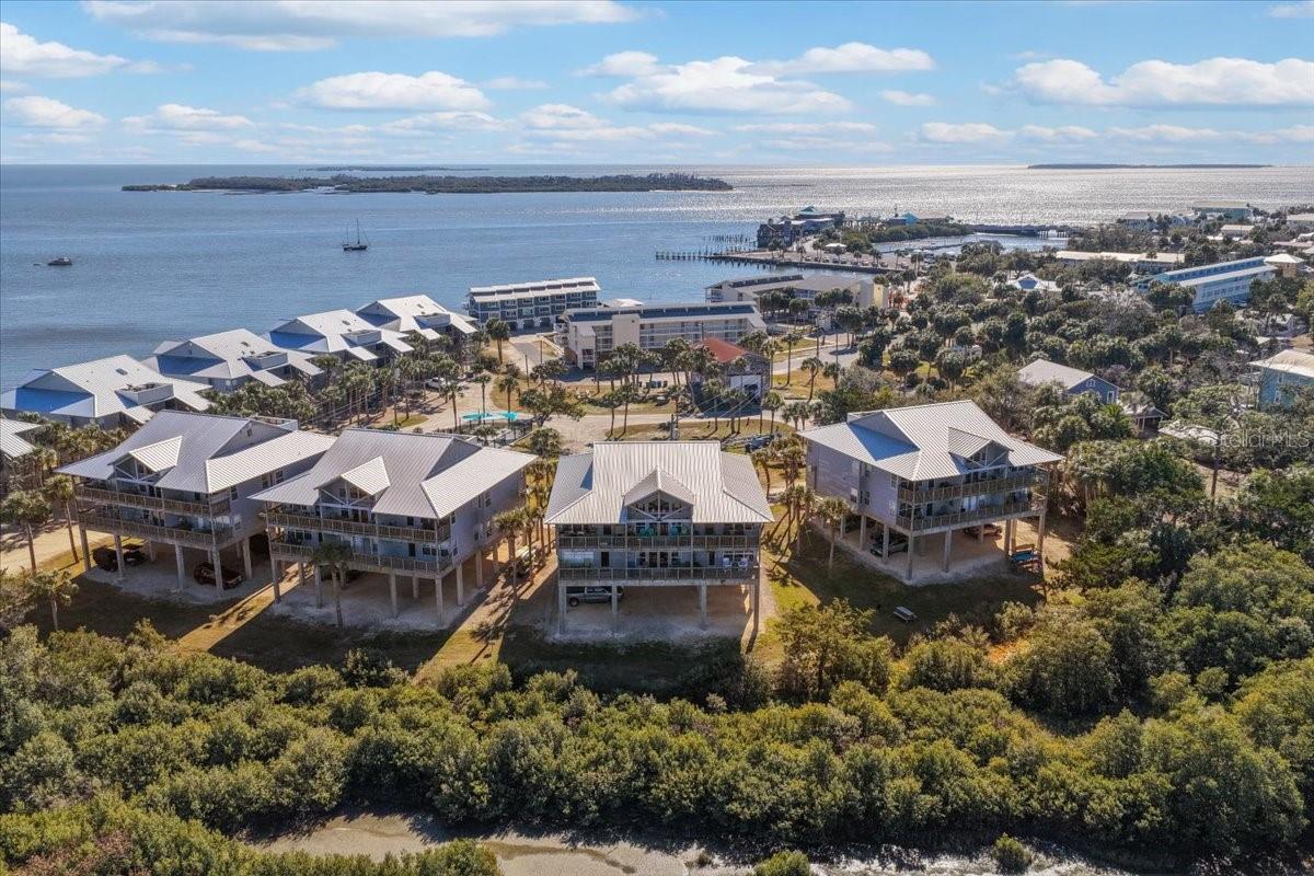 Perfectly remodeled 2 bedroom/2 bathroom condo in Old Fenimore Mill Cedar Key Florida. Cedar Key is the perfect coastal town, seemingly lost in time. Its quaint community offers a true taste of Old Florida , with shops , dining, medical office,, coffee shops and more. It will quickly become an escape from the busy world around you. This condo is immaculate and in excellent condition. As you enter the unit you will see a beautiful foyer and notice the gorgeous tile flooring throughout. A guest bathroom perfectly located in the flood plan near the front door and a gorgeous guest bedroom with tons of natural Florida sunshine. Down the hallway you see the master bedroom which is very spacious, walk in closet and a master bathroom with a gorgeous makeup vanity and sink, combo tub/shower. Laundry room has stacked washer and dryer (included) and plenty of room for storage. Living room is spacious with a priceless view of the coast. Ample space in the dining room. The kitchen was remodeled with convenience in mind, beautiful quartz countertops, smart stove, gorgeous backsplash with a coastal flare, additional plug ins along the bar and a nice open view to the living room and dining room. The balcony is sure to be your most favorite spot, sit and relax and enjoy the sounds of the Gulf of Mexico, the wildlife and peace. Community amenities, like amazing pool and hot tub, boat dock and fish cleaning station, a freshly added swing to enjoy the outdoors! Whether considering your forever home, seasonal home or short term rentals , THIS unit ensures LOW maintenance and is MOVE IN READY! Call today for your tour!