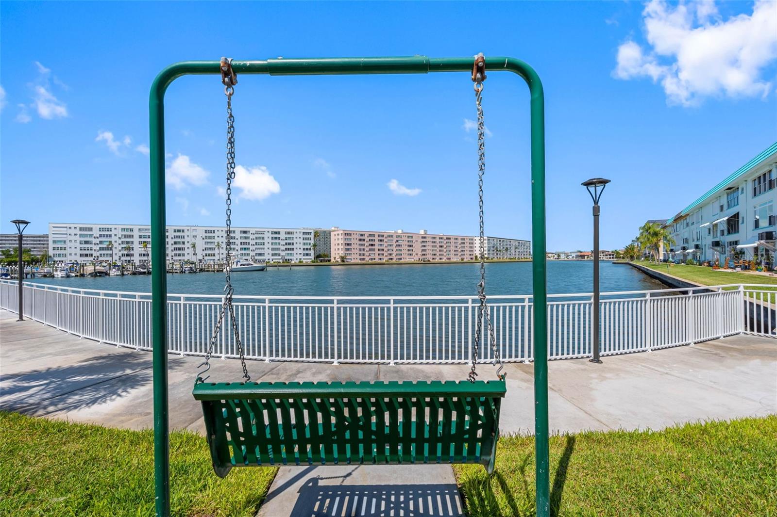 Welcome to waterfront living at its finest in the sought-after 55+ community of Town Shores in the heart of charming Gulfport! This beautifully updated top-floor corner condominium offers breathtaking panoramic views of Boca Ciega Bay and an exceptional coastal lifestyle you'll enjoy every day. This move-in-ready 2-bedroom, 2-bath residence has been thoughtfully renovated with high-end finishes throughout. The stunning kitchen features granite countertops, rich wood cabinetry, a gas range, convection microwave, and a spacious center island that's perfect for cooking, entertaining, or gathering with friends. As an end unit, the home is filled with natural light from additional windows that brighten the open living and dining areas while showcasing the spectacular water views. Quality upgrades include hurricane-impact windows, storm shutters, luxury flooring, beautifully remodeled bathrooms, electric shades throughout, and fresh interior paint. The spacious primary suite opens to the enclosed Florida room and features a generous walk-in closet. Both bathrooms have been updated with walk-in showers and single vanities. The guest bedroom offers a comfortable retreat for family and friends, while the enclosed waterfront Florida room provides the perfect space for a home office, library, or relaxing sitting area where you can unwind while taking in the beautiful bay views. Town Shores offers true resort-style living with an incredible array of amenities, including four heated pools, tennis and pickleball courts, bocce and shuffleboard, kayak storage, docks with boat slips available for rent, waterfront grilling areas, and beautifully maintained grounds. The clubhouse features a fitness center, saunas, billiards, a poker room, arts and crafts studio, library, catering kitchen, and an active social calendar designed to help you enjoy every day. Just minutes away, discover the vibrant Gulfport Arts District with its eclectic boutiques, waterfront restaurants, live music, galleries, and the historic Gulfport Casino. You'll also appreciate the proximity to award-winning Gulf beaches, downtown St. Petersburg, and two major airports. For added peace of mind, the Groton Building has successfully completed the State of Florida Milestone Inspection, and the association's reserves and surplus have funded several recent capital improvement projects. If you've been dreaming of carefree waterfront living with stunning views, outstanding amenities, and an unbeatable location, this exceptional home is ready to welcome you.