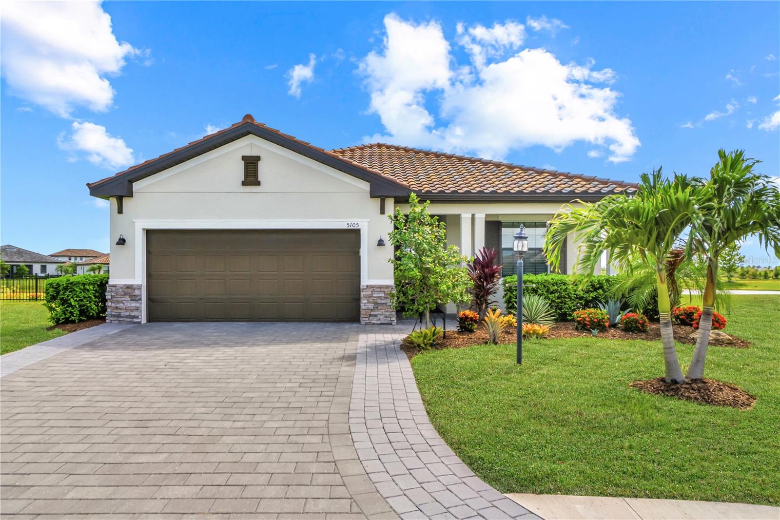 Enjoy the ease of Florida living in this beautifully maintained 3-bedroom, 3-bath home in the highly desirable Lorraine Lakes at Lakewood Ranch. Perfectly situated on an oversized homesite at the end of cul-de-sac with expansive 135 FEET of water views , this Venice floor plan offers the space, comfort, and low-maintenance lifestyle that so many buyers relocating to Southwest Florida are searching for.

Designed with everyday living in mind, the open-concept floor plan creates a welcoming flow between the kitchen, dining area, and main living space. Tile flooring throughout the home provides a clean, cohesive look while making upkeep simple and convenient. The kitchen features plenty of cabinet and counter space, along with an upgraded backsplash and custom island detail that add character and style to the heart of the home.

Step outside and take in the peaceful water views from your screened lanai. The custom heated saltwater pool and spa create the perfect place to relax and enjoy the beautiful Florida weather year-round. An outdoor kitchen makes this a great entertaining space, as well. The oversized lot at the end of a quiet cul-de-sac provides extra outdoor space and a greater sense of privacy, making this homesite stand out from many others in the community. The driveway has been widened on both sides, as well, making it easier to navigate in and out of the garage.

The thoughtfully designed layout offers the perfect balance of privacy and flexibility with 3 full bathrooms and 3 bedrooms. The spacious primary suite serves as a relaxing retreat, featuring a custom-designed walk-in closet and an ensuite bathroom complete with dual vanities and an oversized walk-in shower. At the front of the home, a private guest suite includes its own full ensuite bathroom, creating a comfortable space for visiting family and friends. The third full bathroom is conveniently located to serve both guests and the home's third bedroom, which is currently being used as an office with built-in cabinetry. Whether you need a dedicated workspace, hobby room, or an additional bedroom, the space can easily adapt to your needs. Completing the home is a spacious two-car garage with overhead storage racks and shelving, providing plenty of room for organization and extra storage.

One of the biggest highlights of living in Lorraine Lakes is the incredible resort-style amenities. Residents enjoy access to a 25,000-square-foot amenity center featuring a resort pool, lap pool, fitness center, tennis and pickleball courts, indoor and outdoor basketball courts, splash pad, playground, arcade, putting green, restaurant, tiki bar, and a full calendar of social events and activities. Best of all, lawn maintenance is included, allowing you to spend more time enjoying the lifestyle and less time worrying about yard work. The HOA fees also include basic cable and internet packages, adding to the simplicity of life in Lorraine Lakes.

Located in the heart of Lakewood Ranch, you'll be close to top-rated schools, shopping, dining, golf courses, parks, and some of Florida's most beautiful Gulf Coast beaches. Whether you're relocating, looking for a seasonal home, or simply ready to enjoy a more active and carefree lifestyle, this home offers a wonderful opportunity to experience everything Lakewood Ranch has to offer.